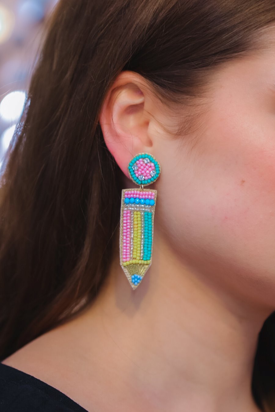 pencil-shaped stud earrings made of colorful beading and rhinestones with a felt backing, a comfort back earring, and a plastic disc stopper in gold