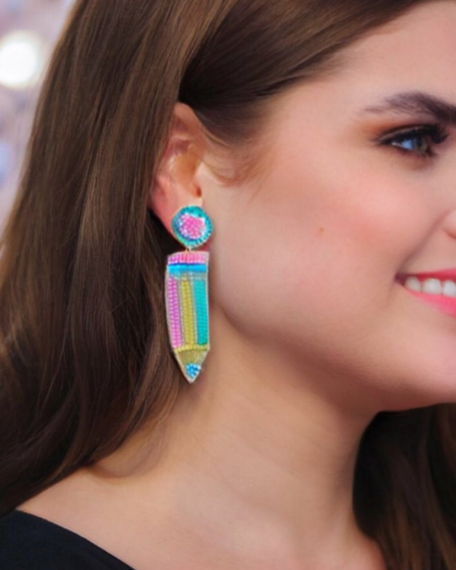 pencil-shaped stud earrings made of colorful beading and rhinestones with a felt backing, a comfort back earring, and a plastic disc stopper in gold