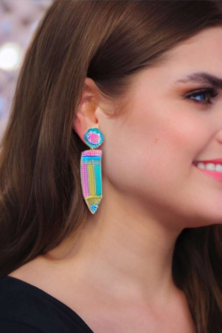 pencil-shaped stud earrings made of colorful beading and rhinestones with a felt backing, a comfort back earring, and a plastic disc stopper in gold