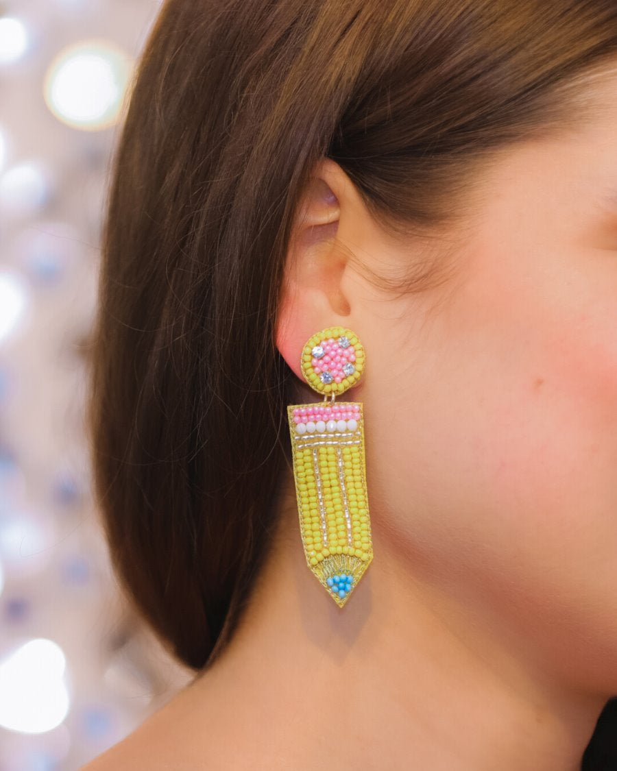 pencil-shaped stud earrings made of colorful beading and rhinestones with a felt backing, a comfort back earring, and a plastic disc stopper in gold