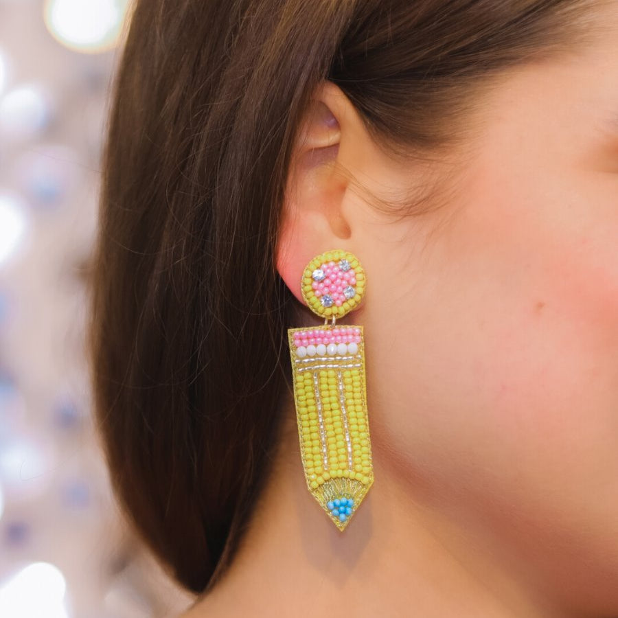 pencil-shaped stud earrings made of colorful beading and rhinestones with a felt backing, a comfort back earring, and a plastic disc stopper in gold