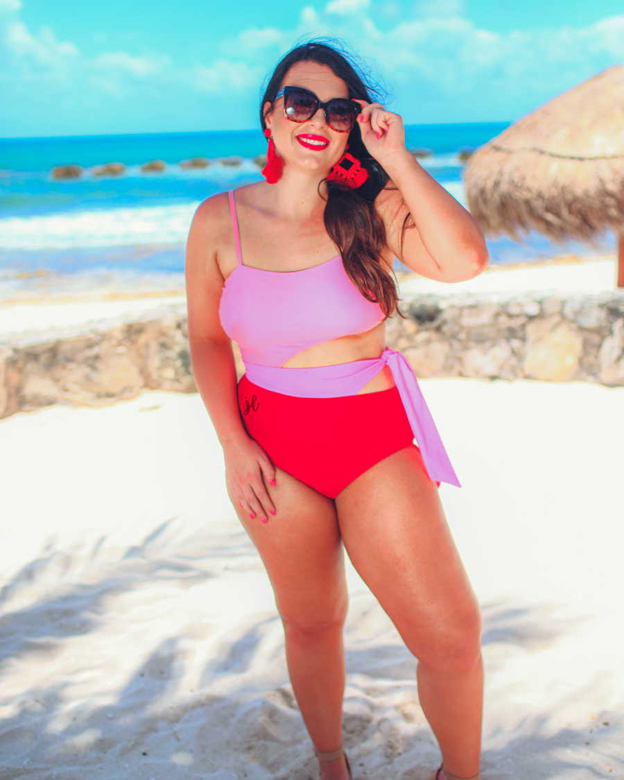 two-tone one-piece swimsuit made of stretchy material with adjustable spaghetti straps that can crisscross in back, a side cutout with a wraparound tie, and removable padding