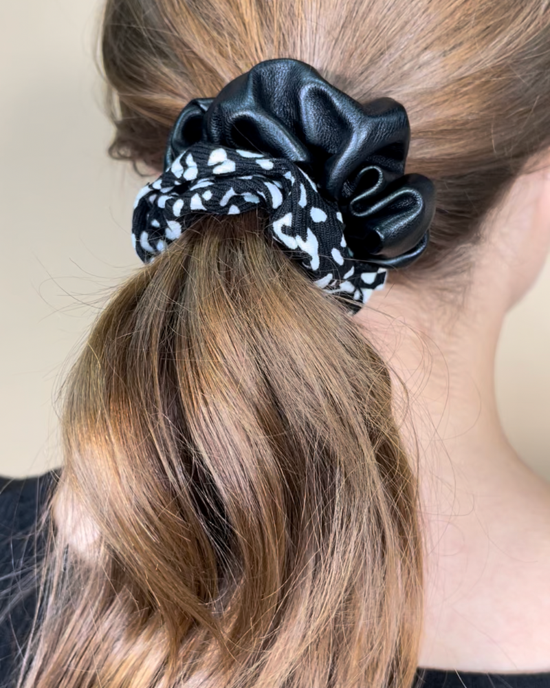 a classic pleather scrunchie paired with bold animal print and elastic in black