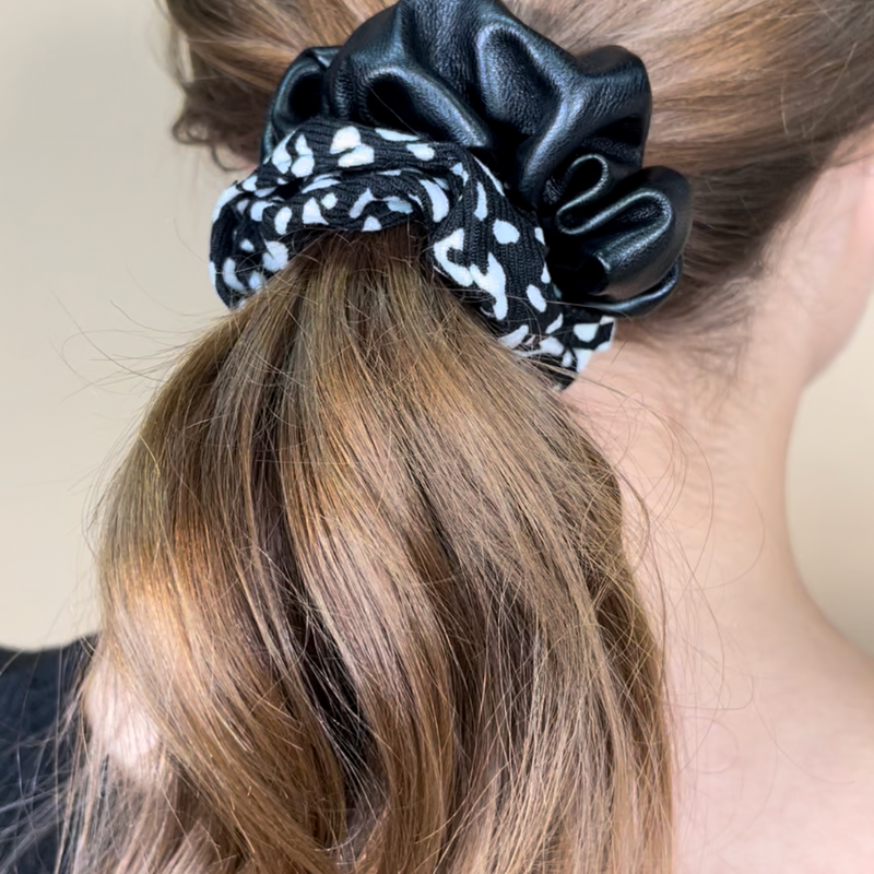 a classic pleather scrunchie paired with bold animal print and elastic in black