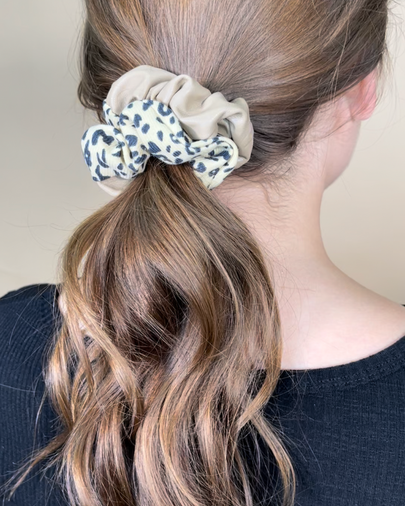 a classic pleather scrunchie paired with bold animal print and elastic in taupe