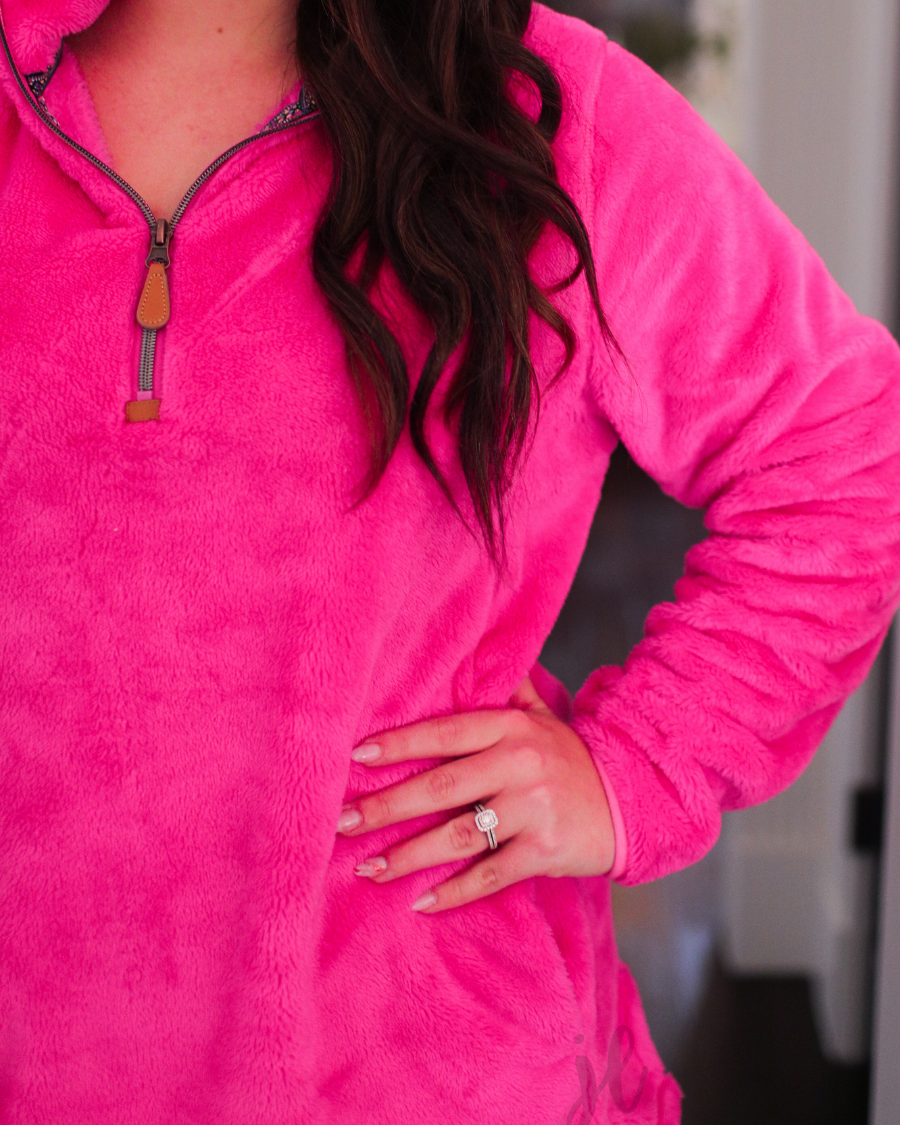 long-sleeve plush fleece pullover with quarter zip, front pockets, and a foldable collar on a super soft hot pink fabric