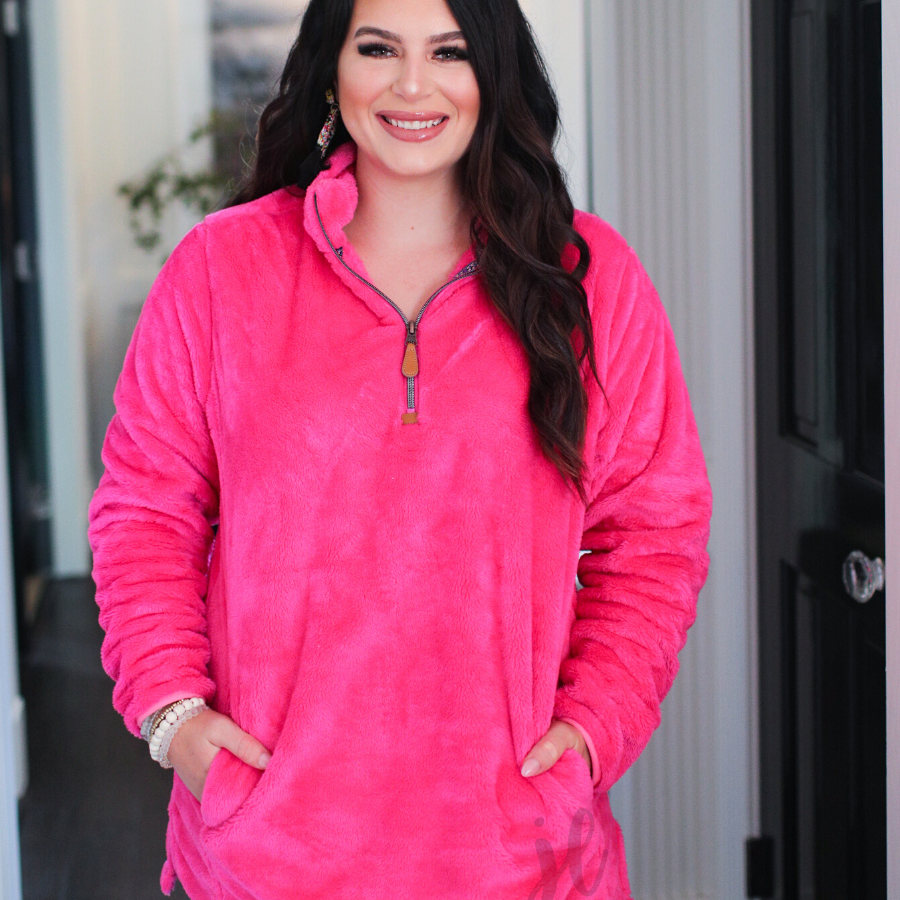 long-sleeve plush fleece pullover with quarter zip, front pockets, and a foldable collar on a super soft hot pink fabric