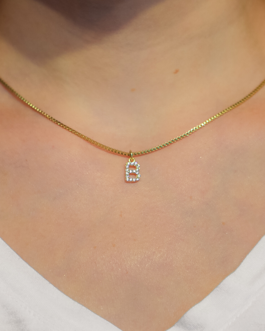 gold chain necklace with rhinestone-studded 'B' initial charm