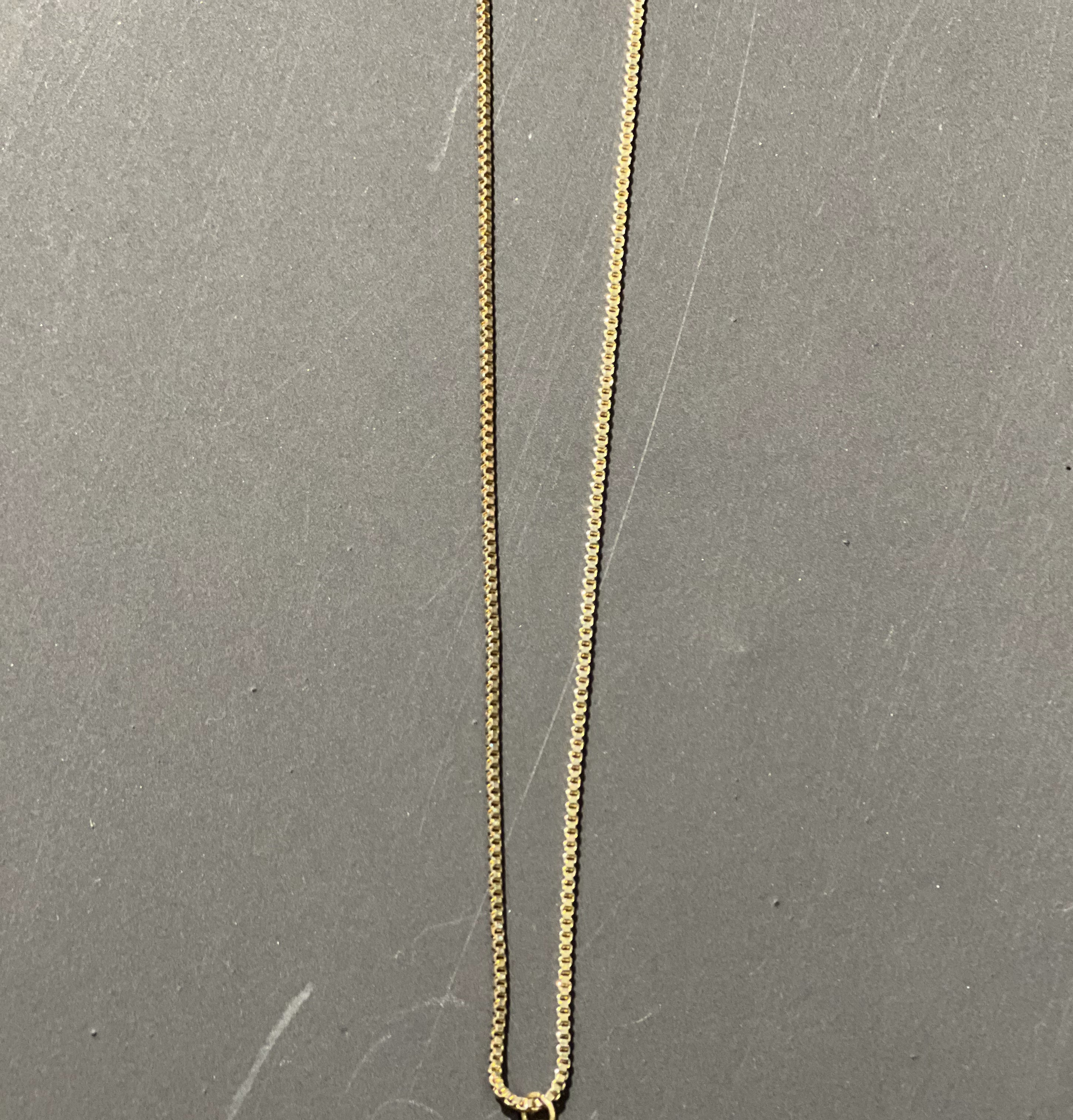 gold chain necklace with rhinestone-studded 'B' initial charm