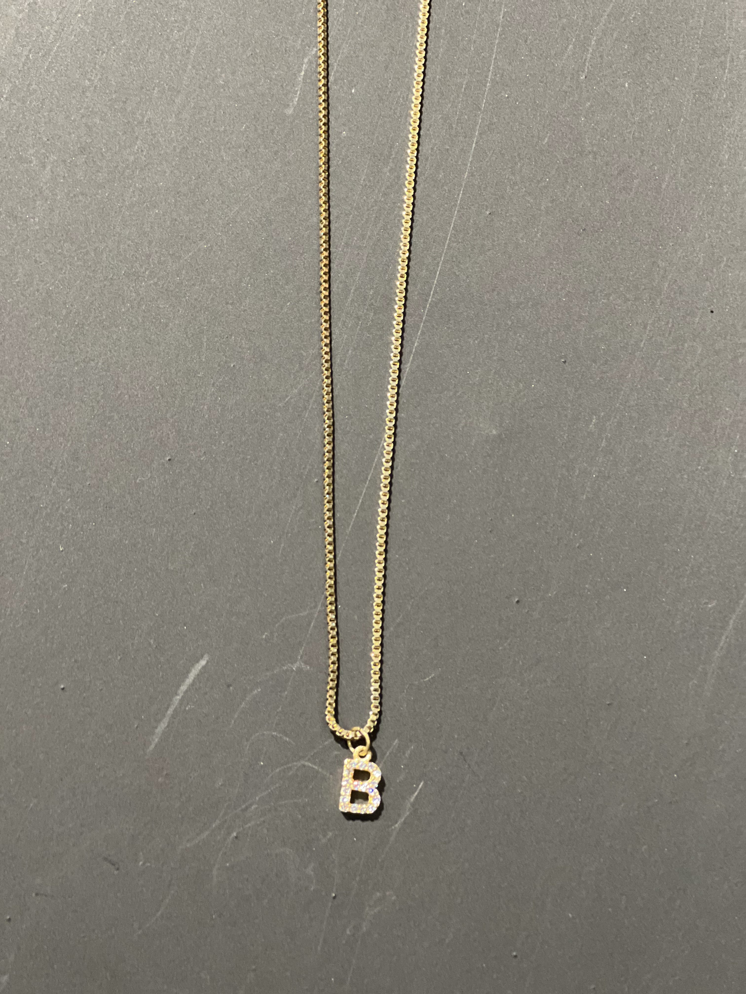 gold chain necklace with rhinestone-studded 'B' initial charm
