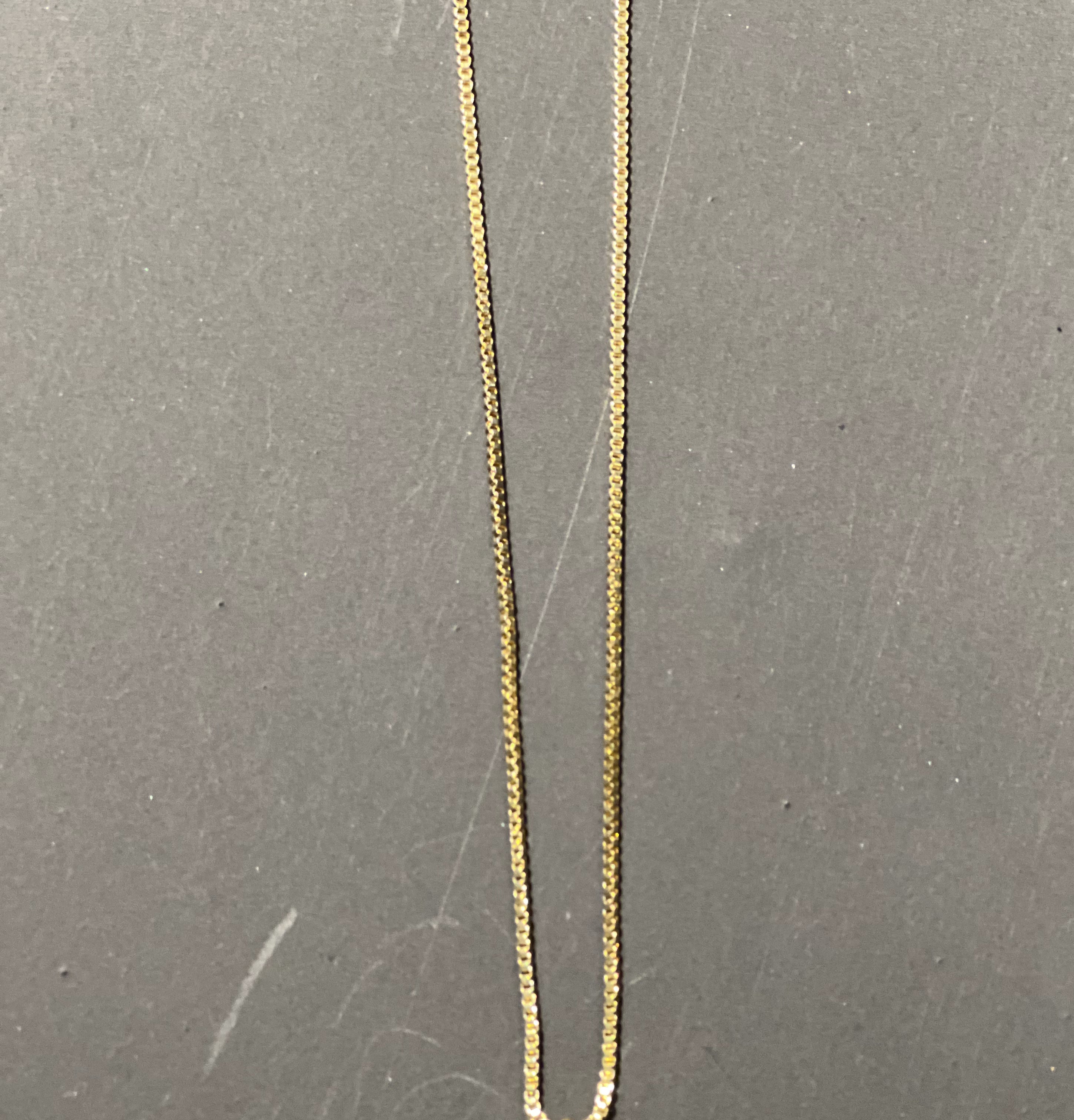 gold chain necklace with rhinestone-studded 'C' initial charm