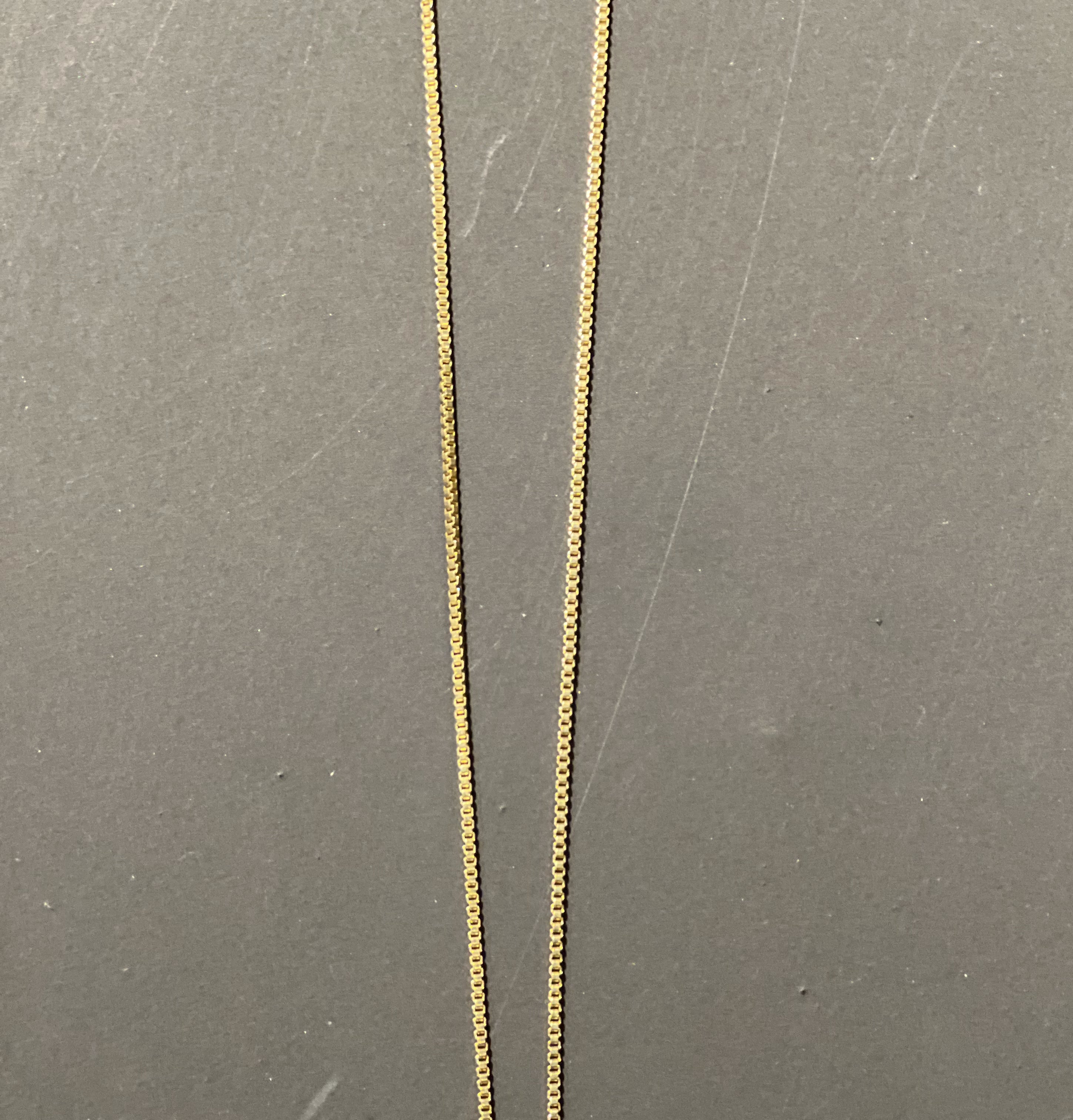 gold chain necklace with rhinestone-studded 'H' initial charm