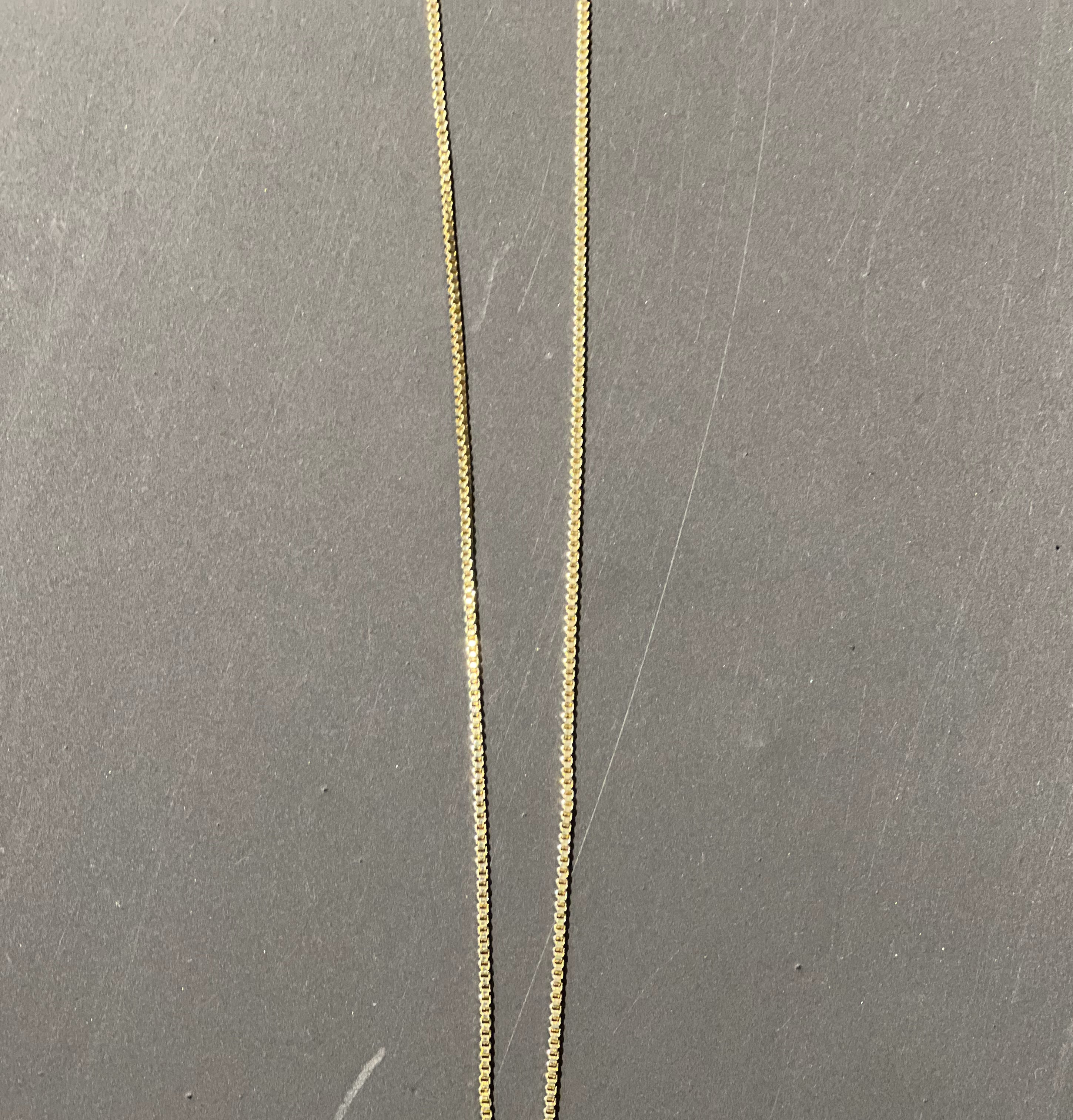 gold chain necklace with rhinestone-studded 'J' initial charm