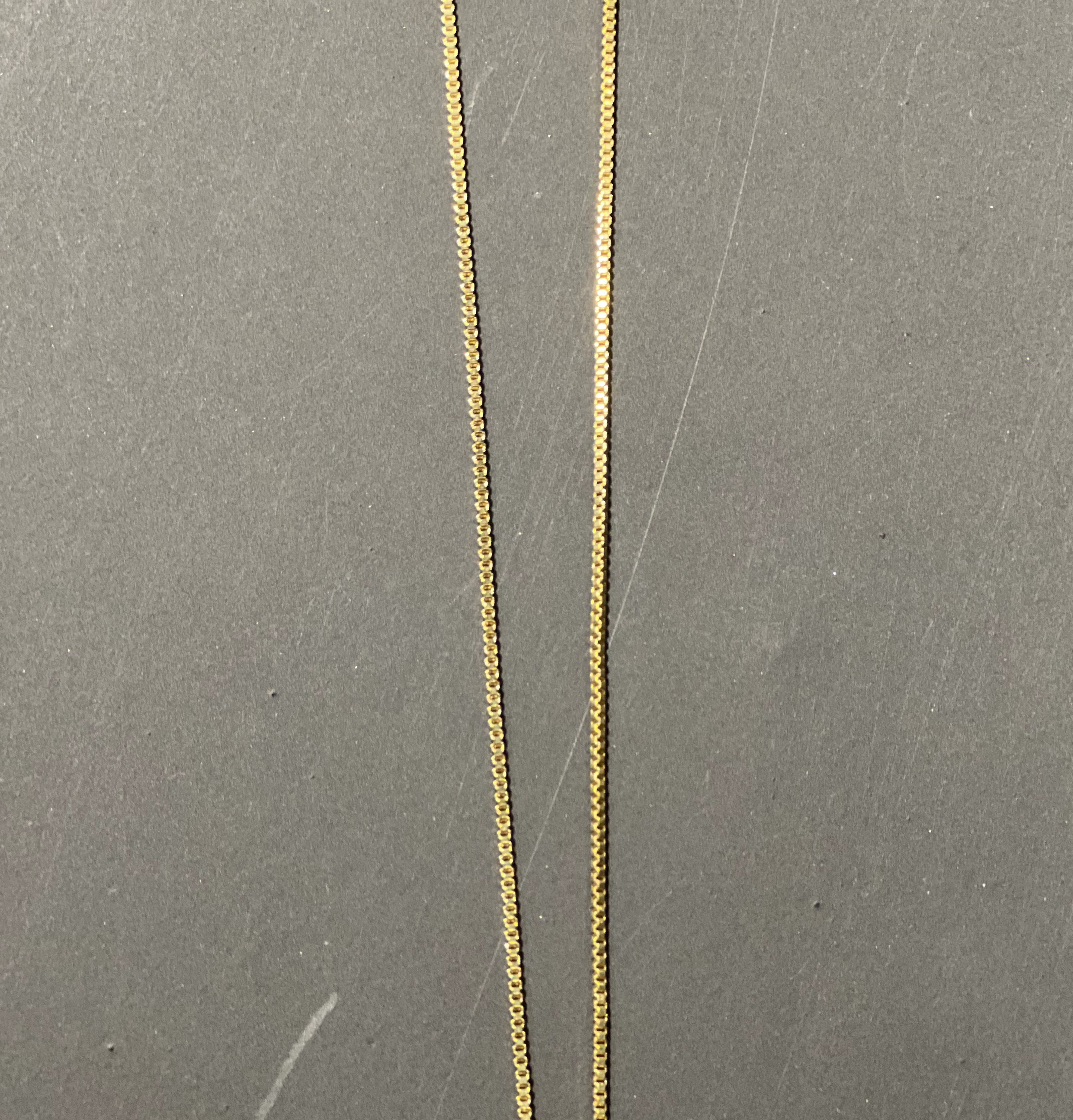 gold chain necklace with rhinestone-studded 'K' initial charm