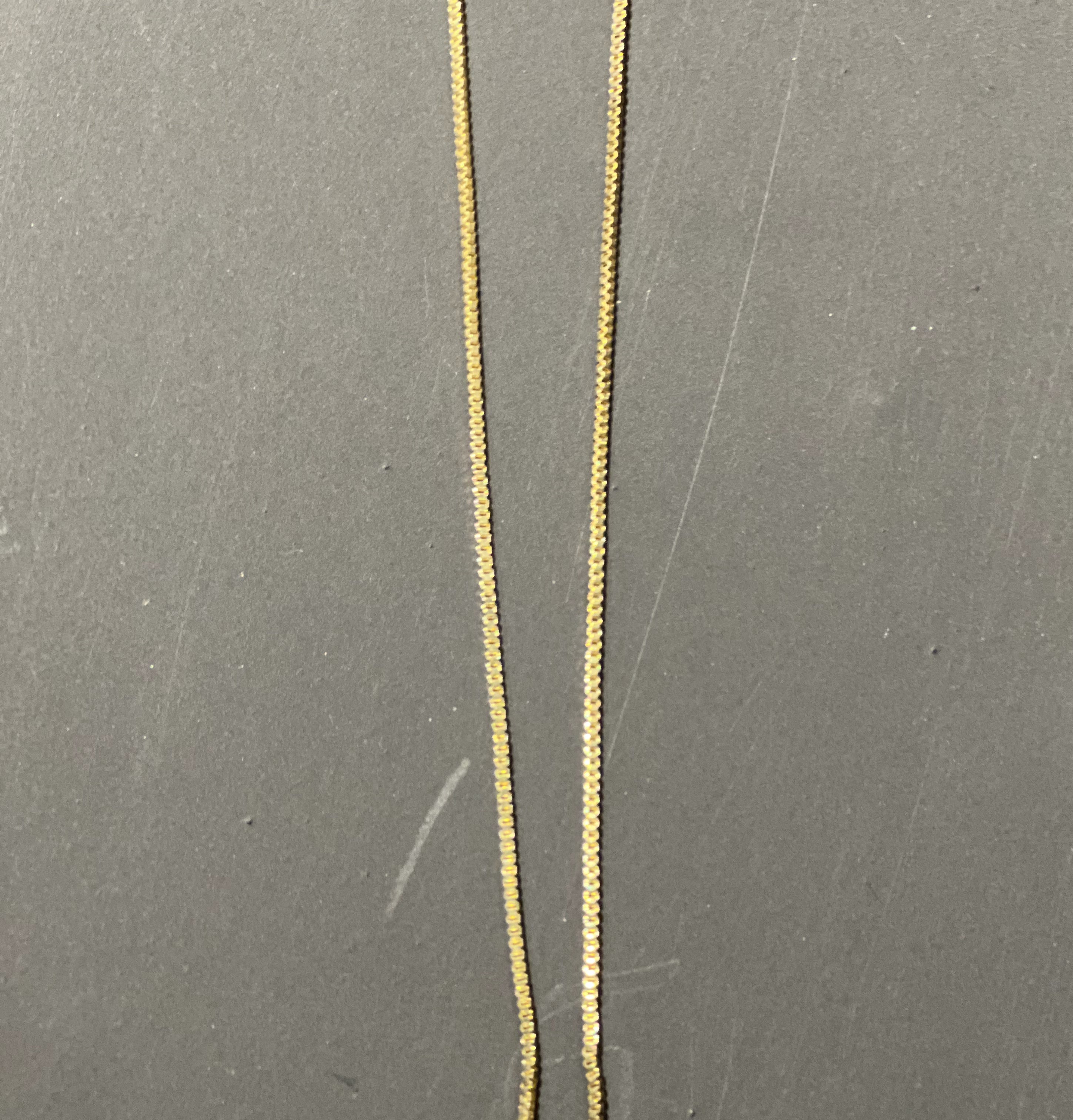 gold chain necklace with rhinestone-studded 'L initial charm