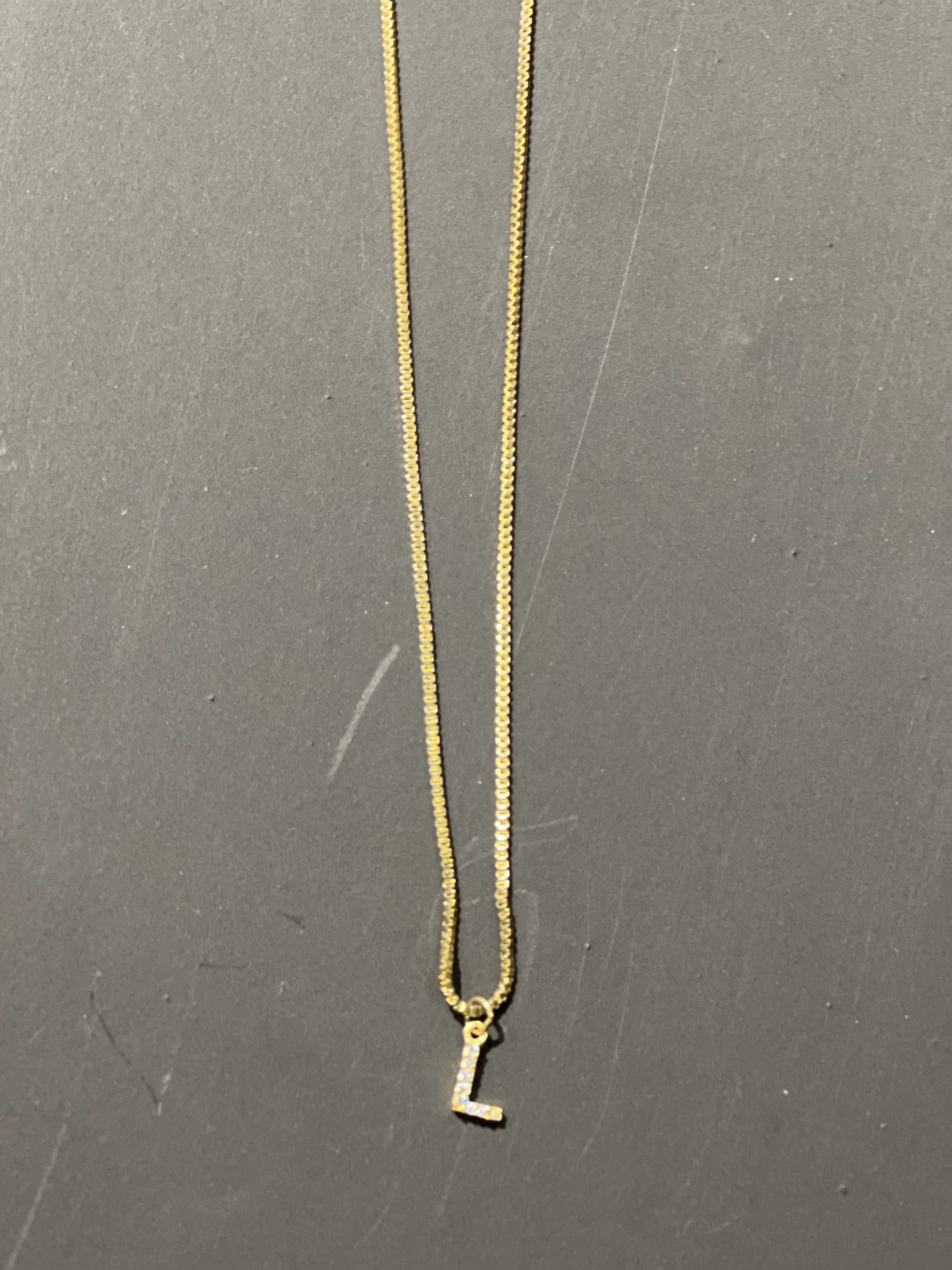 gold chain necklace with rhinestone-studded 'L initial charm