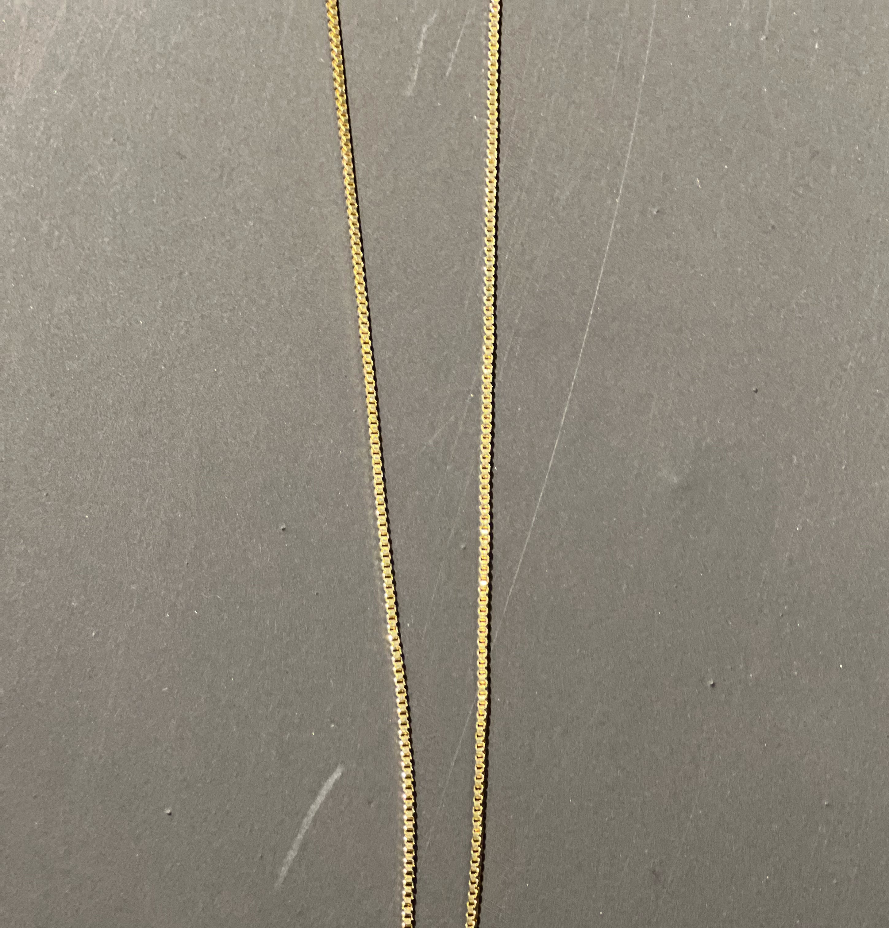 gold chain necklace with rhinestone-studded 'M' initial charm