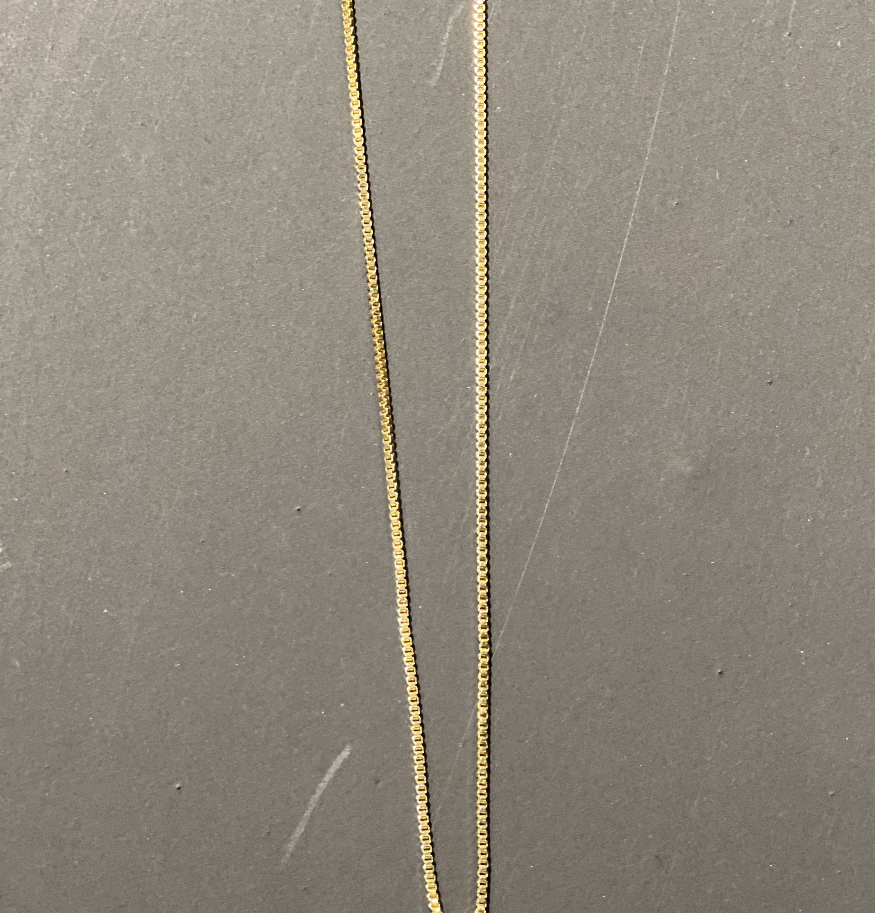 gold chain necklace with rhinestone-studded 'R' initial charm