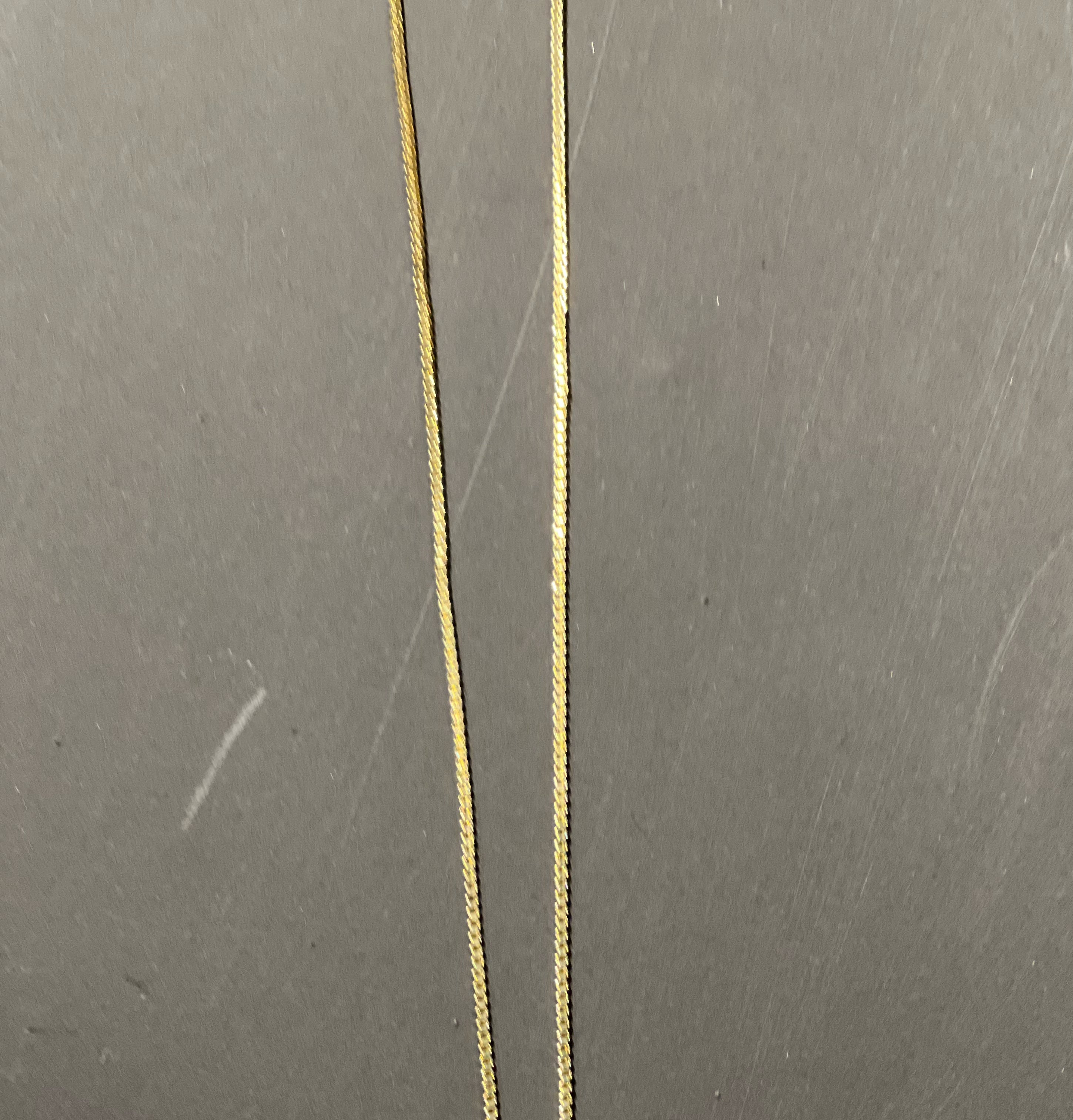 gold chain necklace with rhinestone-studded 'S' initial charm