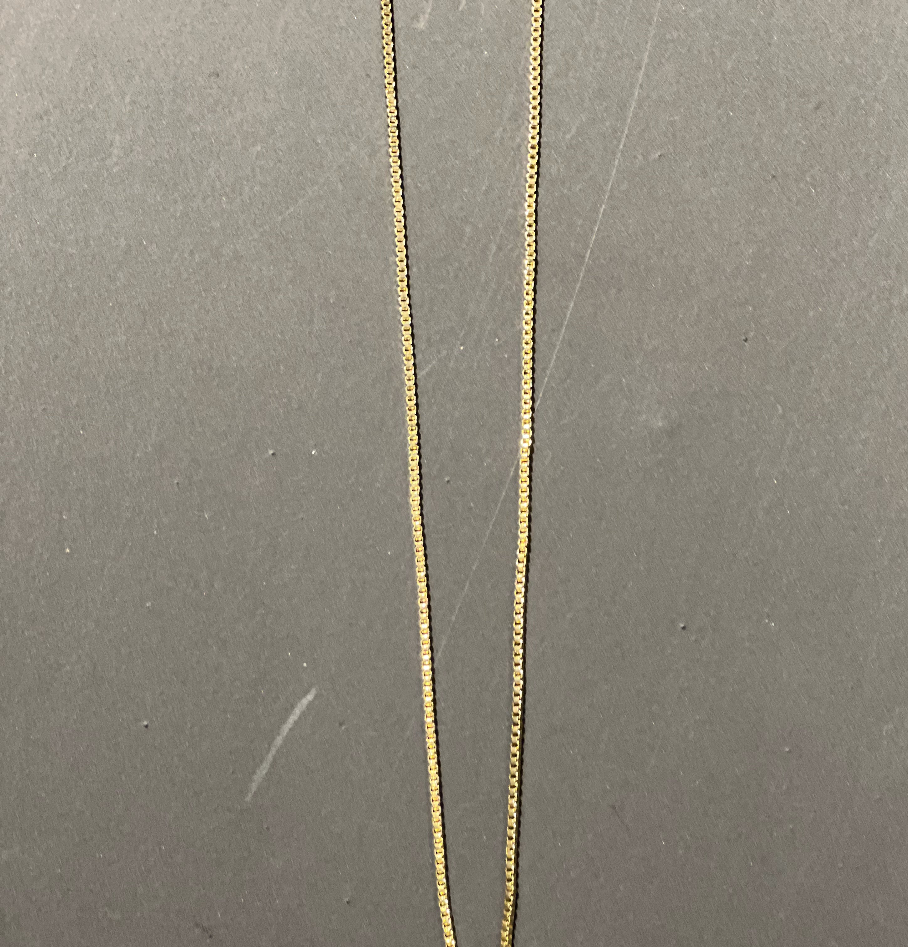 gold chain necklace with rhinestone-studded 'T initial charm