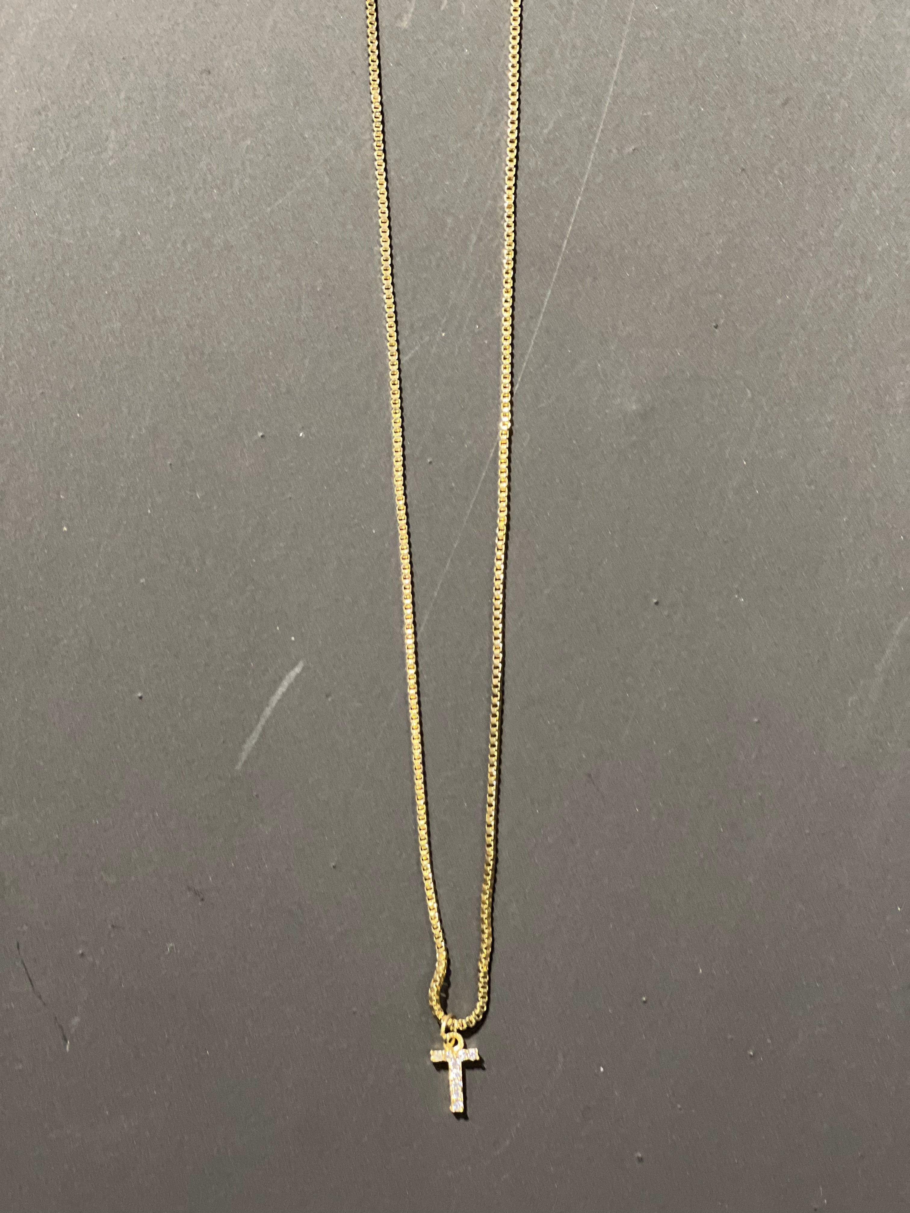 gold chain necklace with rhinestone-studded 'T initial charm