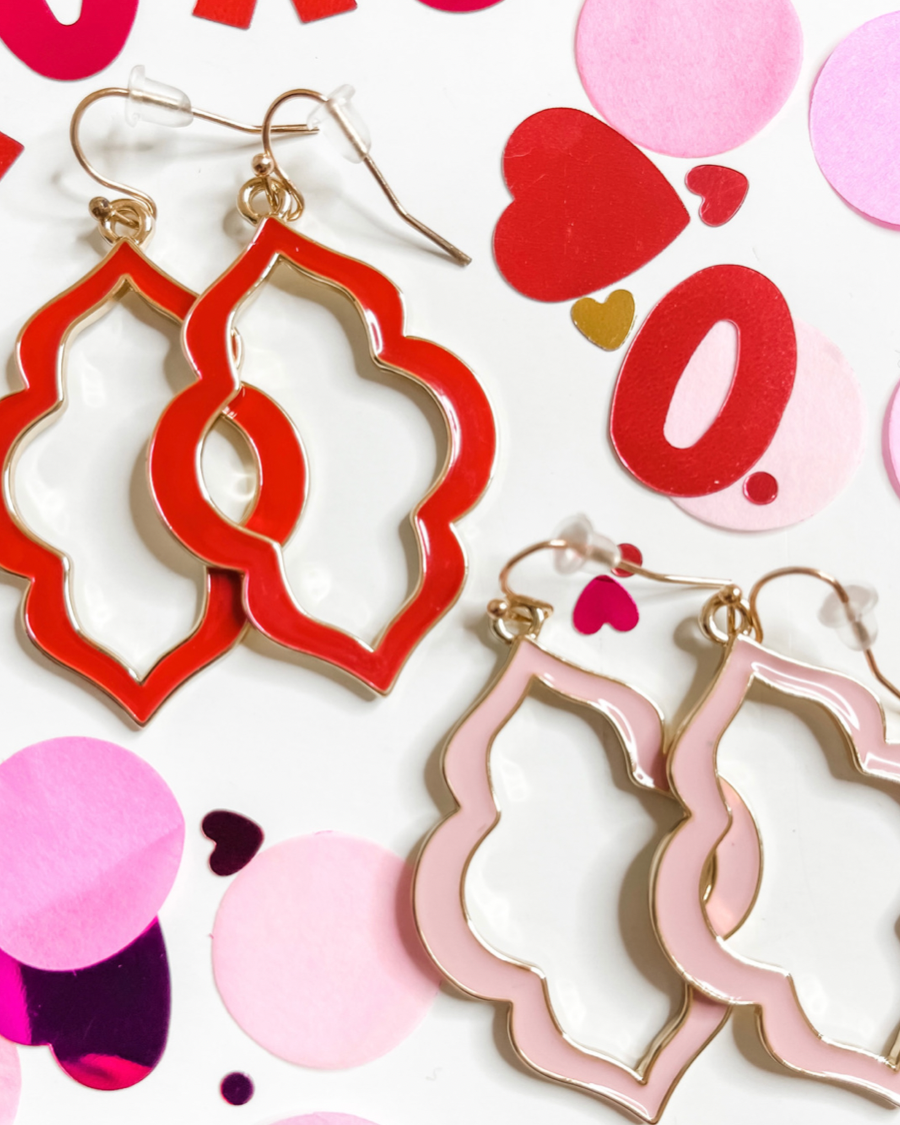 quatrefoil-shaped hook earrings with colored enamel centers in pink and red