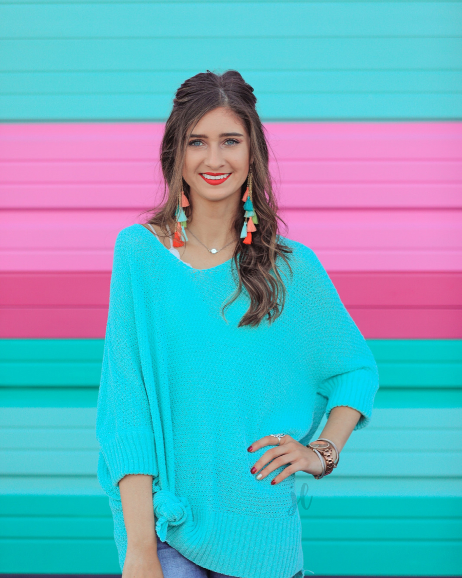 lightweight oversized tunic made of loosely knitted material with three-quarter sleeves, a hi-lo hemline, side slits, and a relaxed drape for easy, all-day wear in aqua