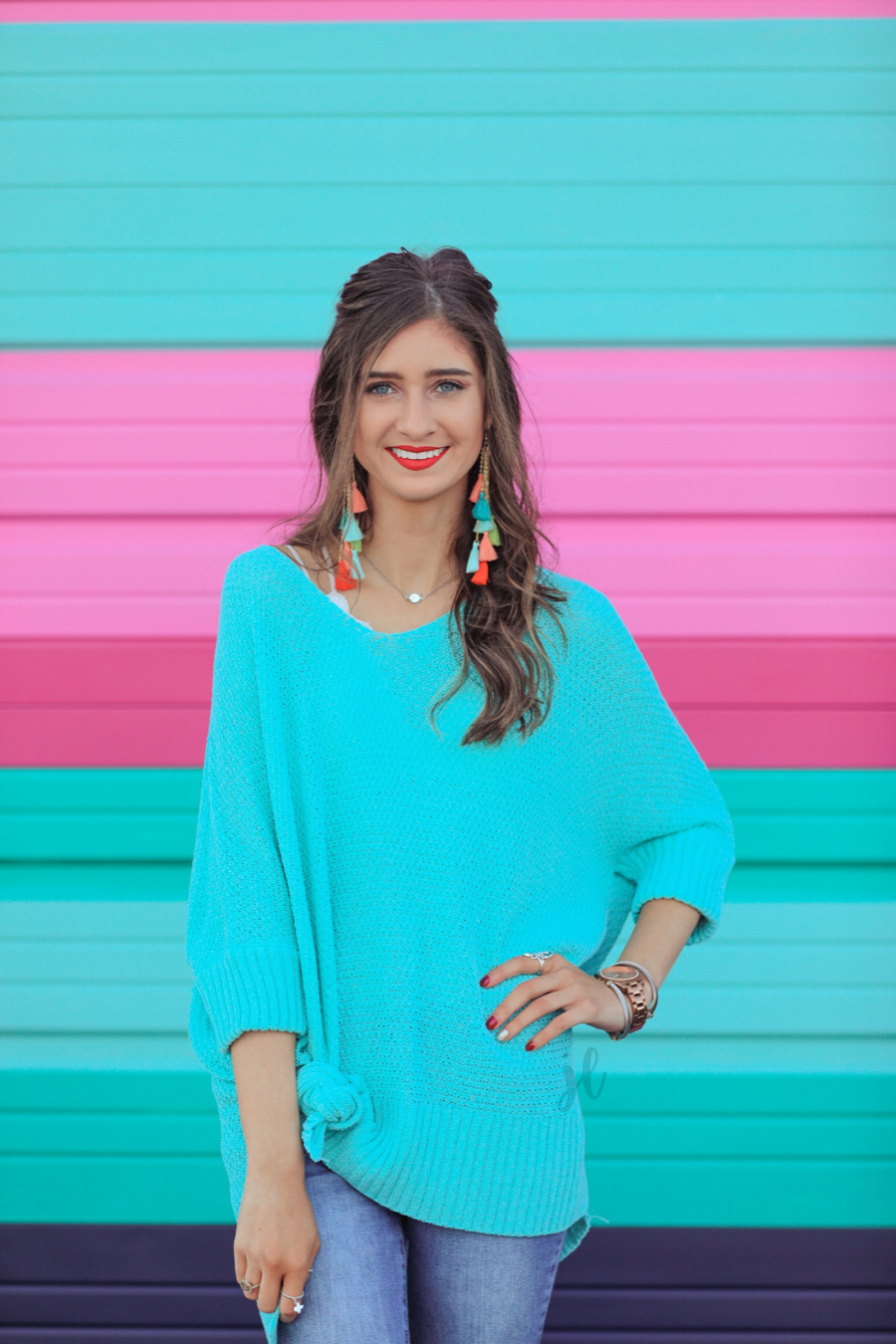 lightweight oversized tunic made of loosely knitted material with three-quarter sleeves, a hi-lo hemline, side slits, and a relaxed drape for easy, all-day wear in aqua