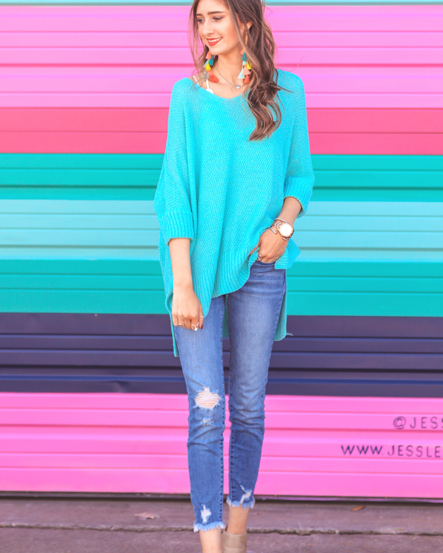 lightweight oversized tunic made of loosely knitted material with three-quarter sleeves, a hi-lo hemline, side slits, and a relaxed drape for easy, all-day wear in aqua