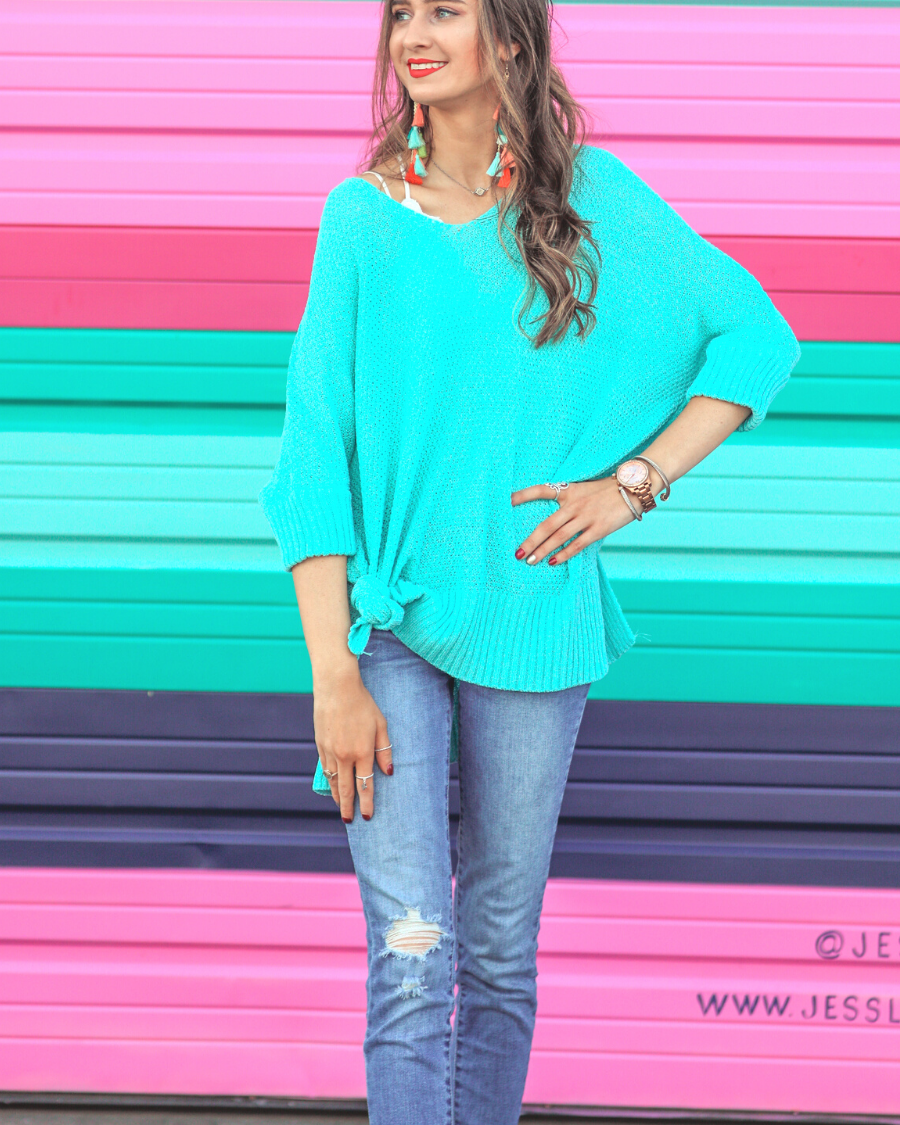 lightweight oversized tunic made of loosely knitted material with three-quarter sleeves, a hi-lo hemline, side slits, and a relaxed drape for easy, all-day wear in aqua
