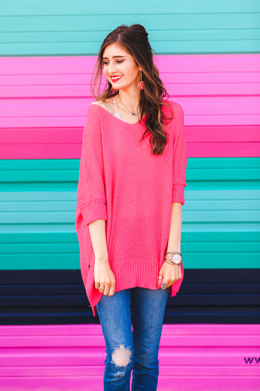 lightweight oversized tunic made of loosely knitted material with three-quarter sleeves, a hi-lo hemline, side slits, and a relaxed drape for easy, all-day wear in pink