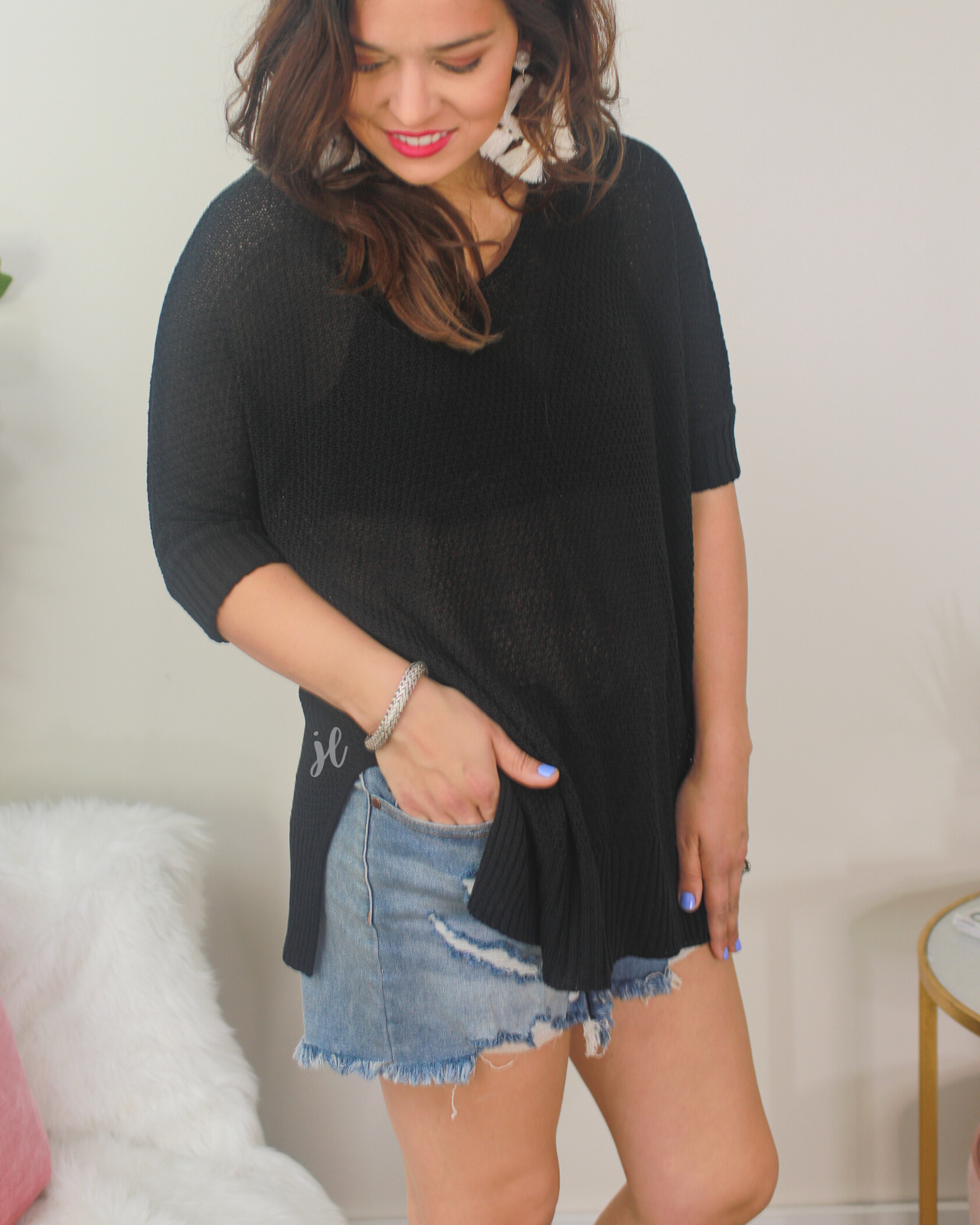 lightweight oversized tunic made of loosely knitted material with three-quarter sleeves, a hi-lo hemline, side slits, and a relaxed drape for easy, all-day wear in black