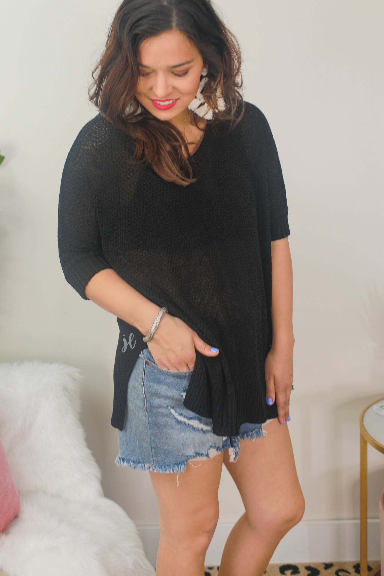 lightweight oversized tunic made of loosely knitted material with three-quarter sleeves, a hi-lo hemline, side slits, and a relaxed drape for easy, all-day wear in black