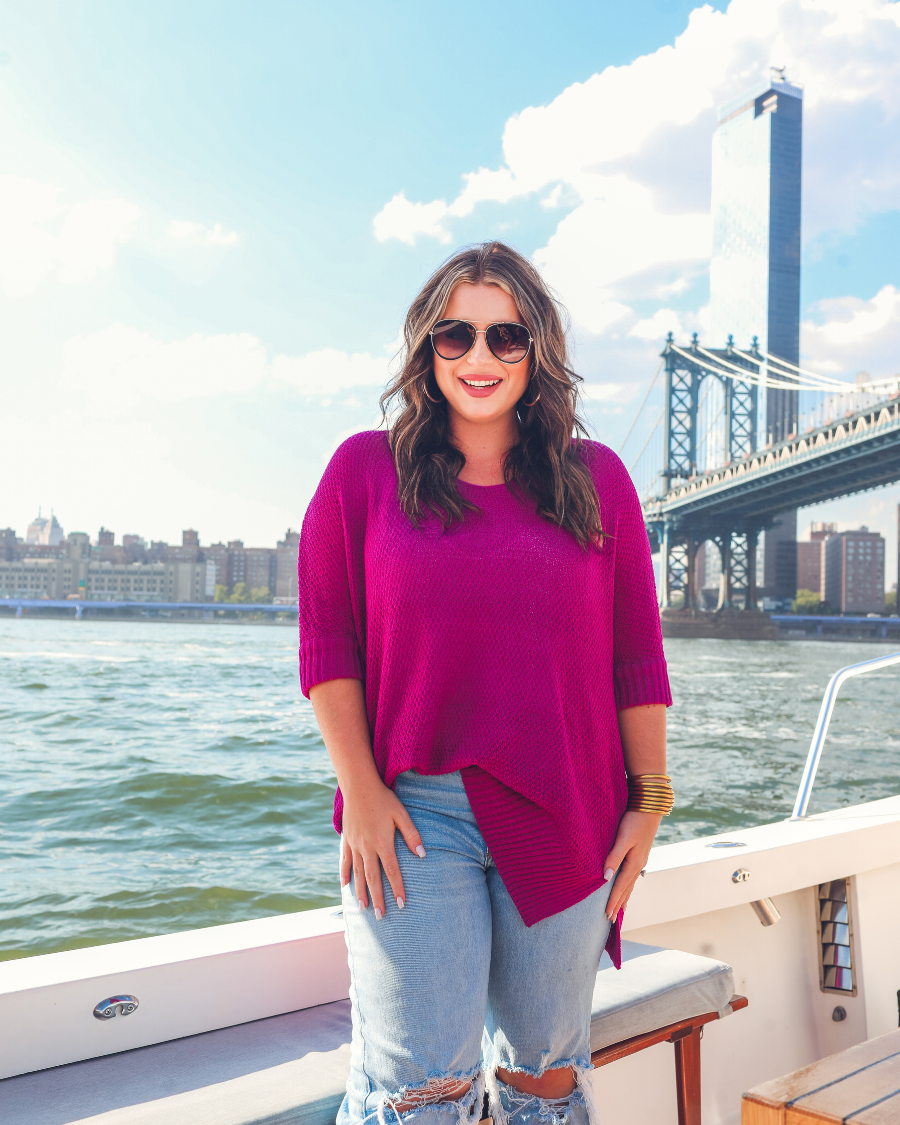 lightweight oversized tunic made of loosely knitted material with three-quarter sleeves, a hi-lo hemline, side slits, and a relaxed drape for easy, all-day wear in magenta
