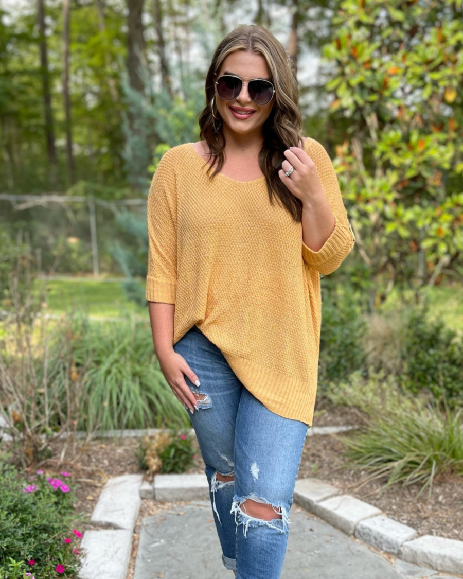 lightweight oversized tunic made of loosely knitted material with three-quarter sleeves, a hi-lo hemline, side slits, and a relaxed drape for easy, all-day wear in honey