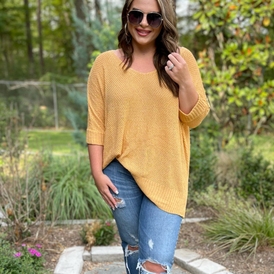 lightweight oversized tunic made of loosely knitted material with three-quarter sleeves, a hi-lo hemline, side slits, and a relaxed drape for easy, all-day wear in honey