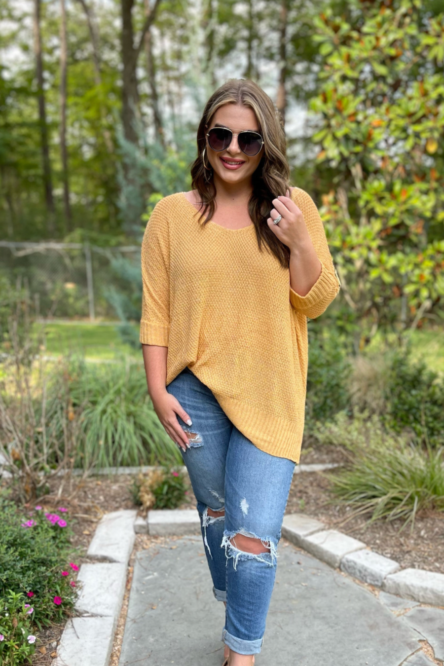 lightweight oversized tunic made of loosely knitted material with three-quarter sleeves, a hi-lo hemline, side slits, and a relaxed drape for easy, all-day wear in honey