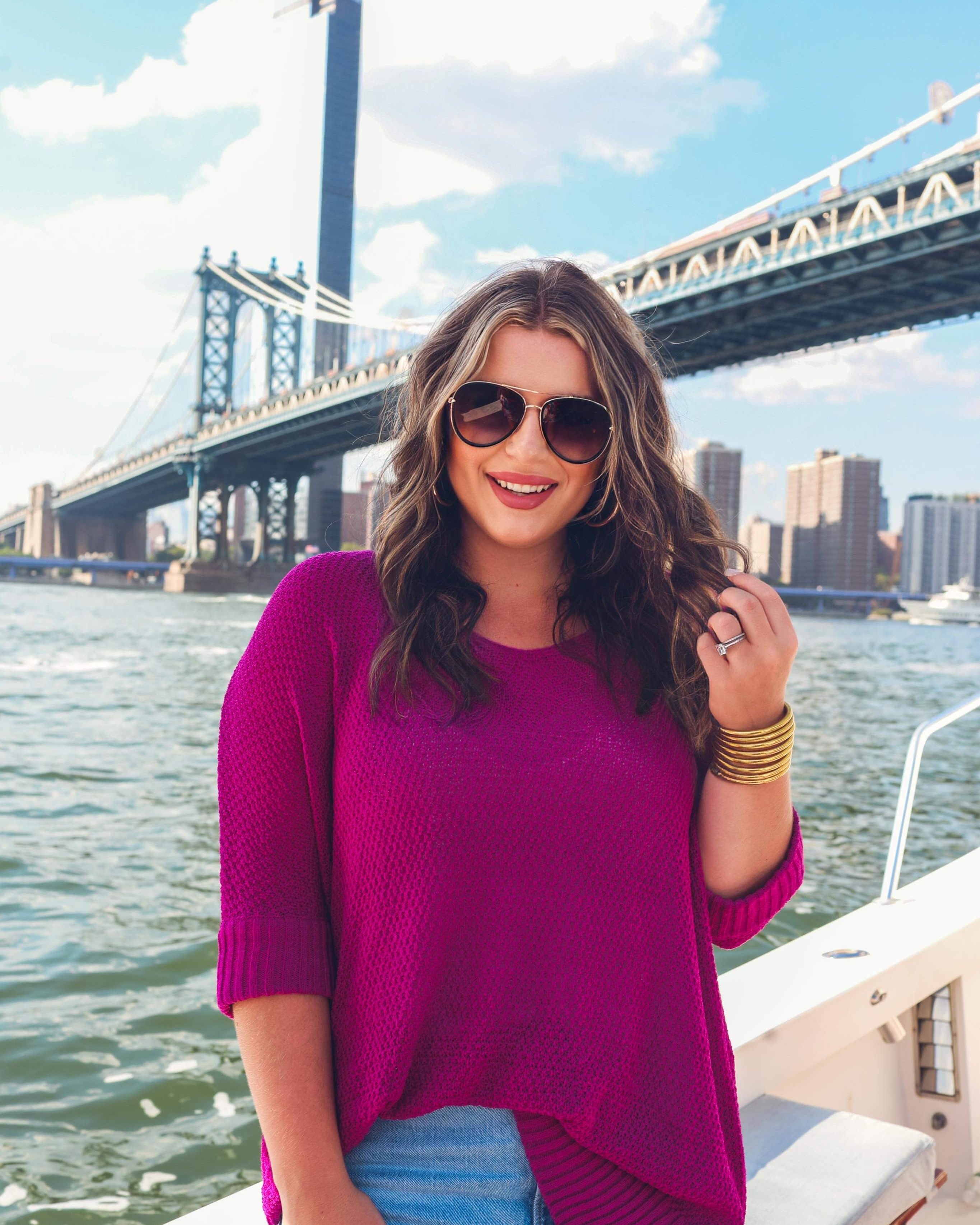 lightweight oversized tunic made of loosely knitted material with three-quarter sleeves, a hi-lo hemline, side slits, and a relaxed drape for easy, all-day wear in magenta