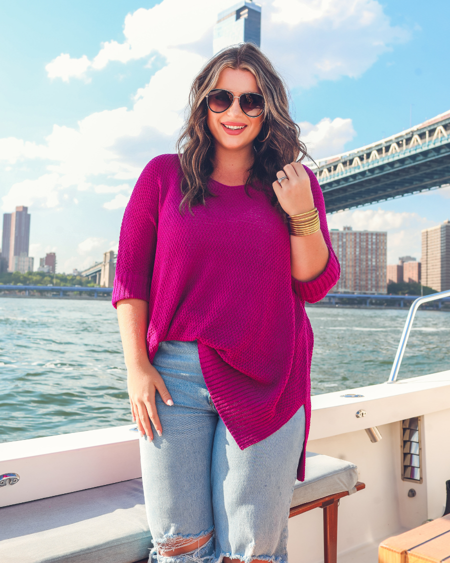 lightweight oversized tunic made of loosely knitted material with three-quarter sleeves, a hi-lo hemline, side slits, and a relaxed drape for easy, all-day wear in magenta