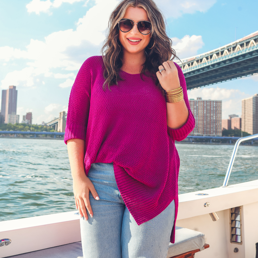 lightweight oversized tunic made of loosely knitted material with three-quarter sleeves, a hi-lo hemline, side slits, and a relaxed drape for easy, all-day wear in magenta