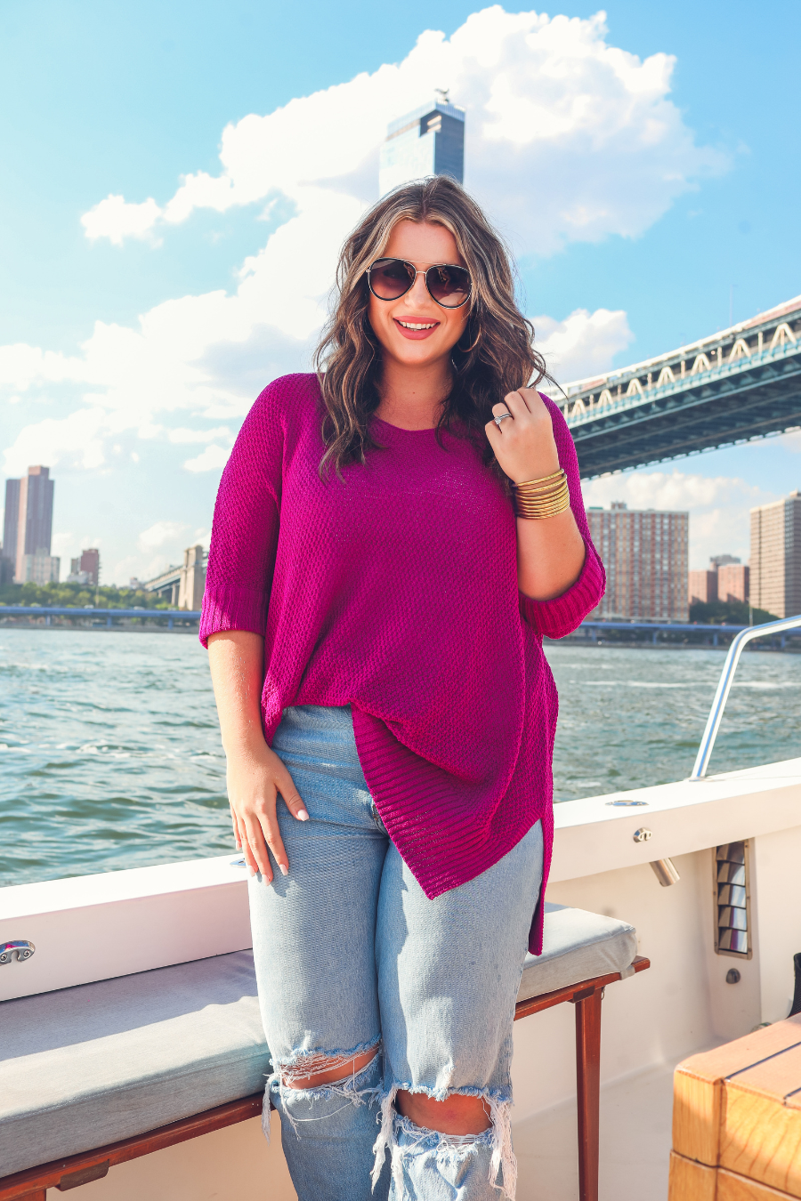 lightweight oversized tunic made of loosely knitted material with three-quarter sleeves, a hi-lo hemline, side slits, and a relaxed drape for easy, all-day wear in magenta