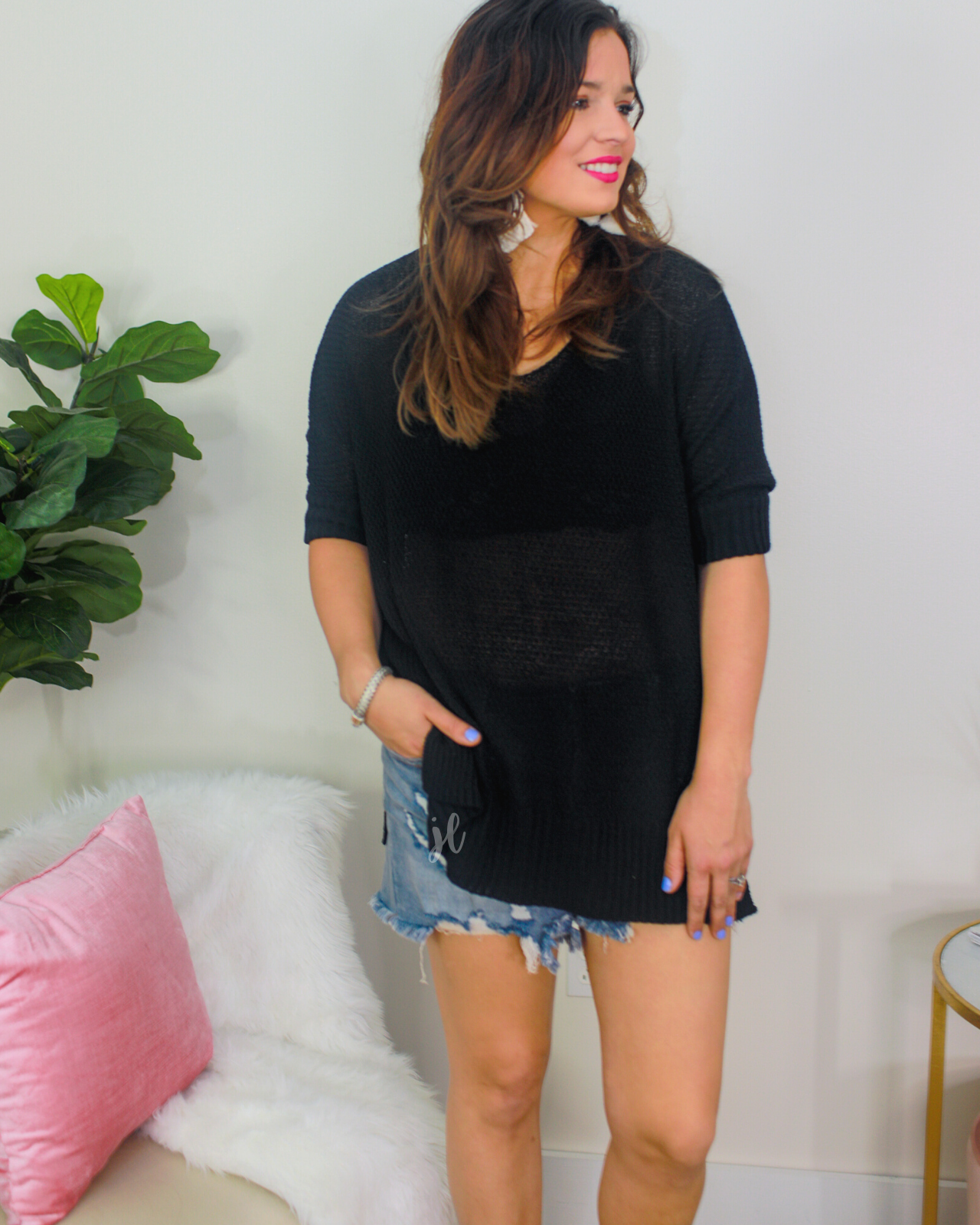 lightweight oversized tunic made of loosely knitted material with three-quarter sleeves, a hi-lo hemline, side slits, and a relaxed drape for easy, all-day wear in black