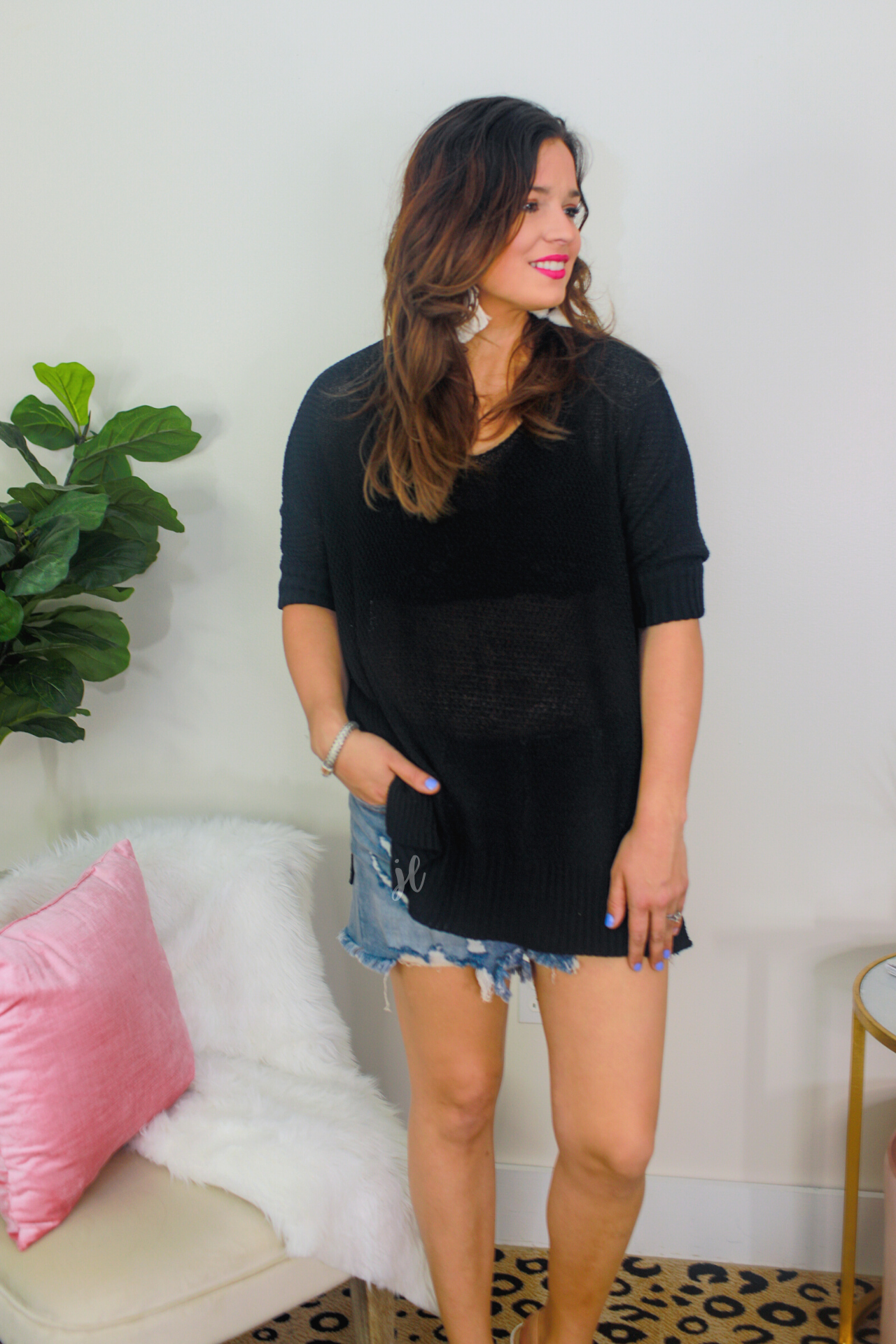 lightweight oversized tunic made of loosely knitted material with three-quarter sleeves, a hi-lo hemline, side slits, and a relaxed drape for easy, all-day wear in black