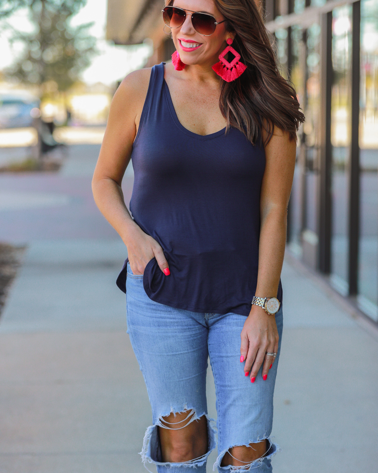a sleeveless style tank with a v-neck neckline, side slits, a back center seam, and a rounded hi-lo hemline in navy