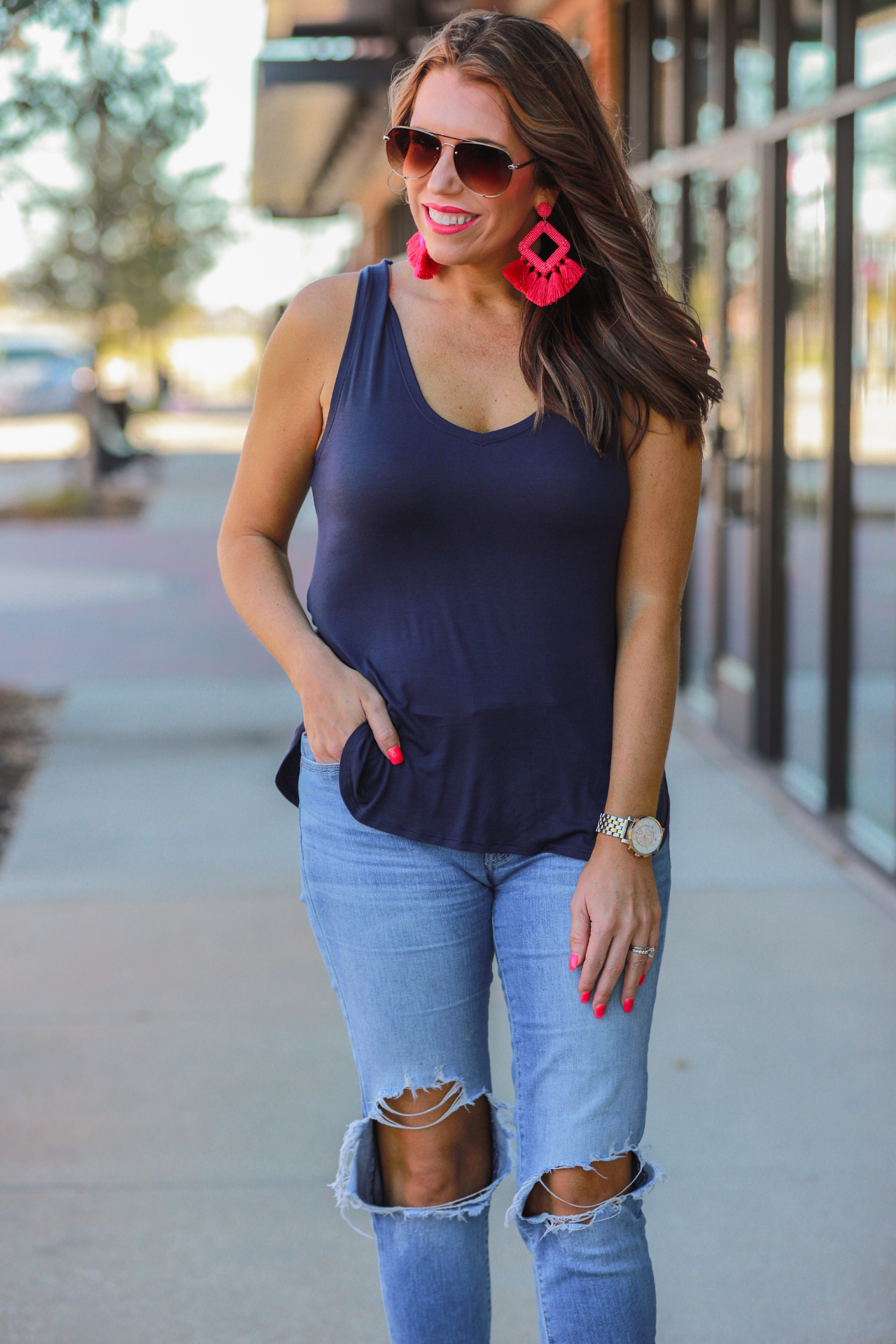 a sleeveless style tank with a v-neck neckline, side slits, a back center seam, and a rounded hi-lo hemline in navy