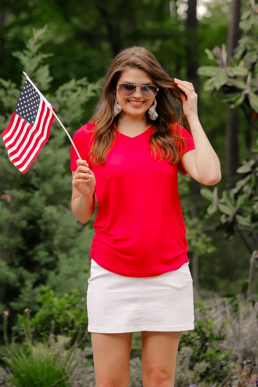 short-sleeved tee made of soft, breathable fabric with a V-neckline and a rounded hemline in red