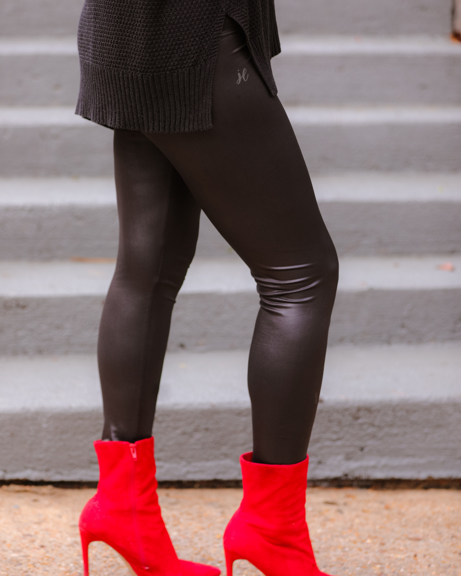 solid black lightweight leggings crafted from figure hugging faux leather with a high rise elastic waistband for tummy control and ankle length silhouette