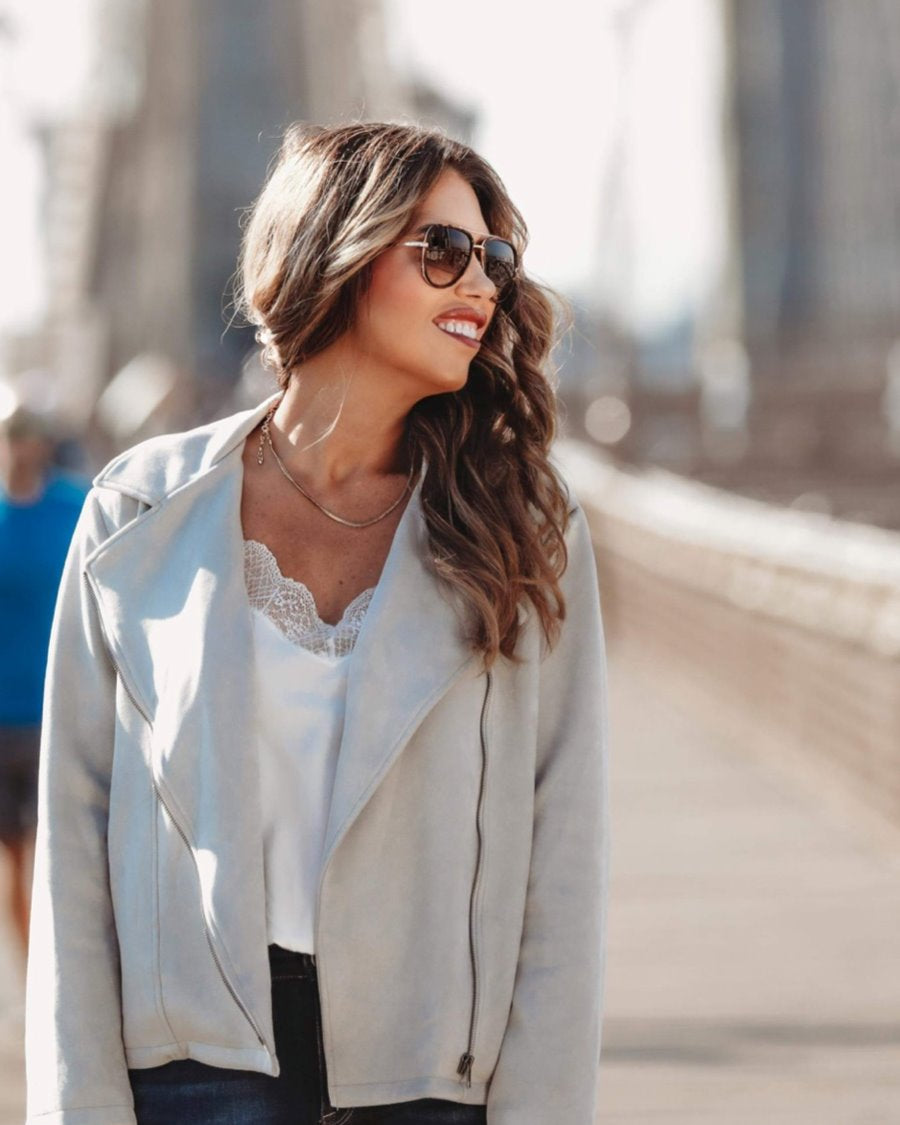 long sleeve faux suede grey jacket made of soft material with an oblique zipper closure, a classic collar, and side pockets