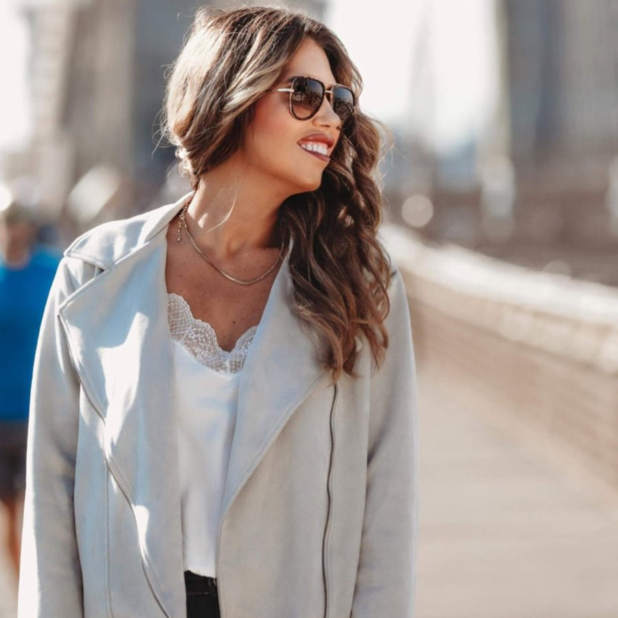 long sleeve faux suede grey jacket made of soft material with an oblique zipper closure, a classic collar, and side pockets