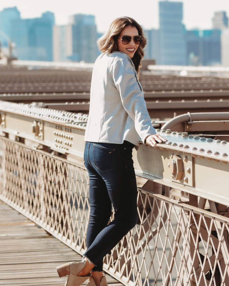 long sleeve faux suede grey jacket made of soft material with an oblique zipper closure, a classic collar, and side pockets